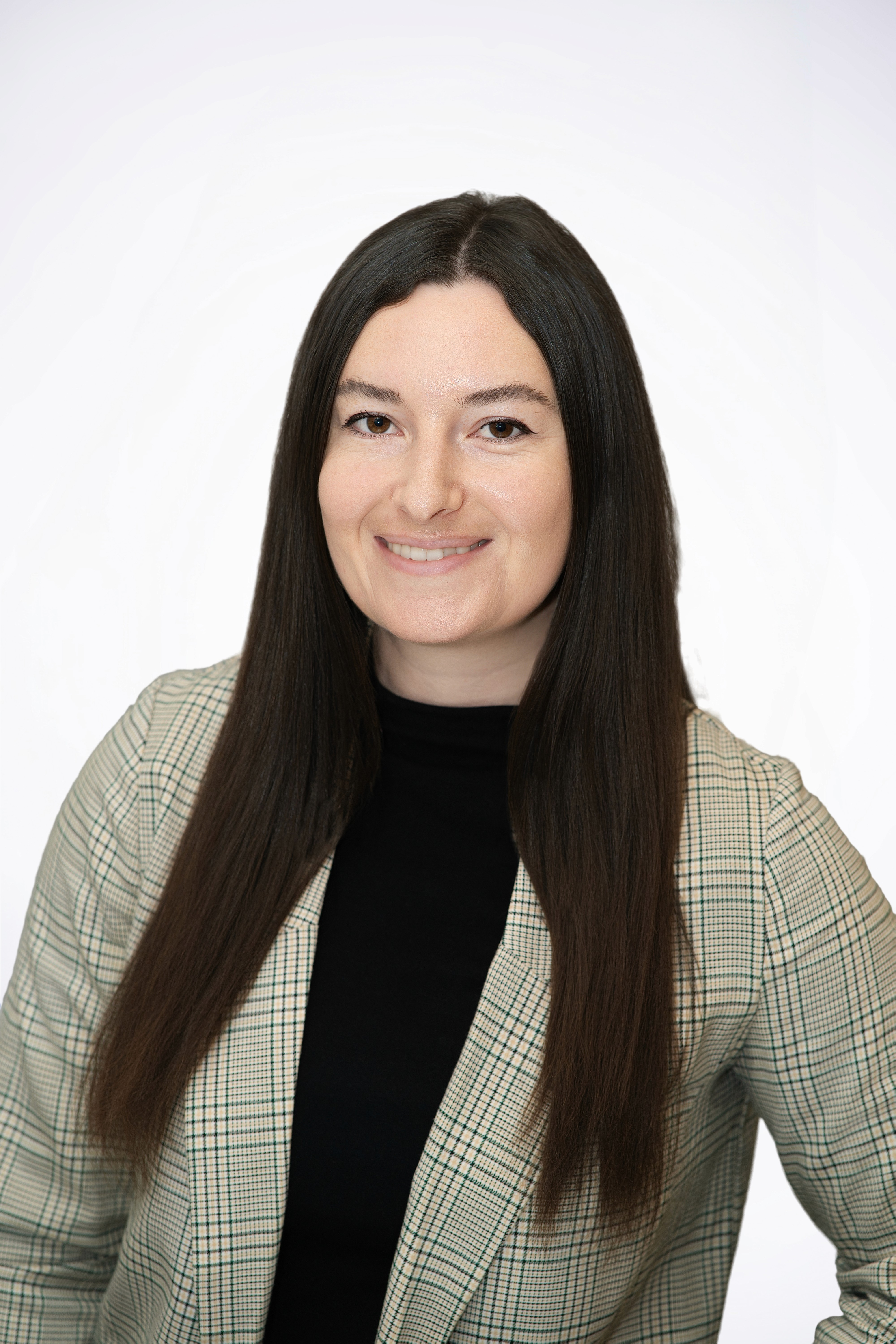 Scientist looking through a microscope in a lab.