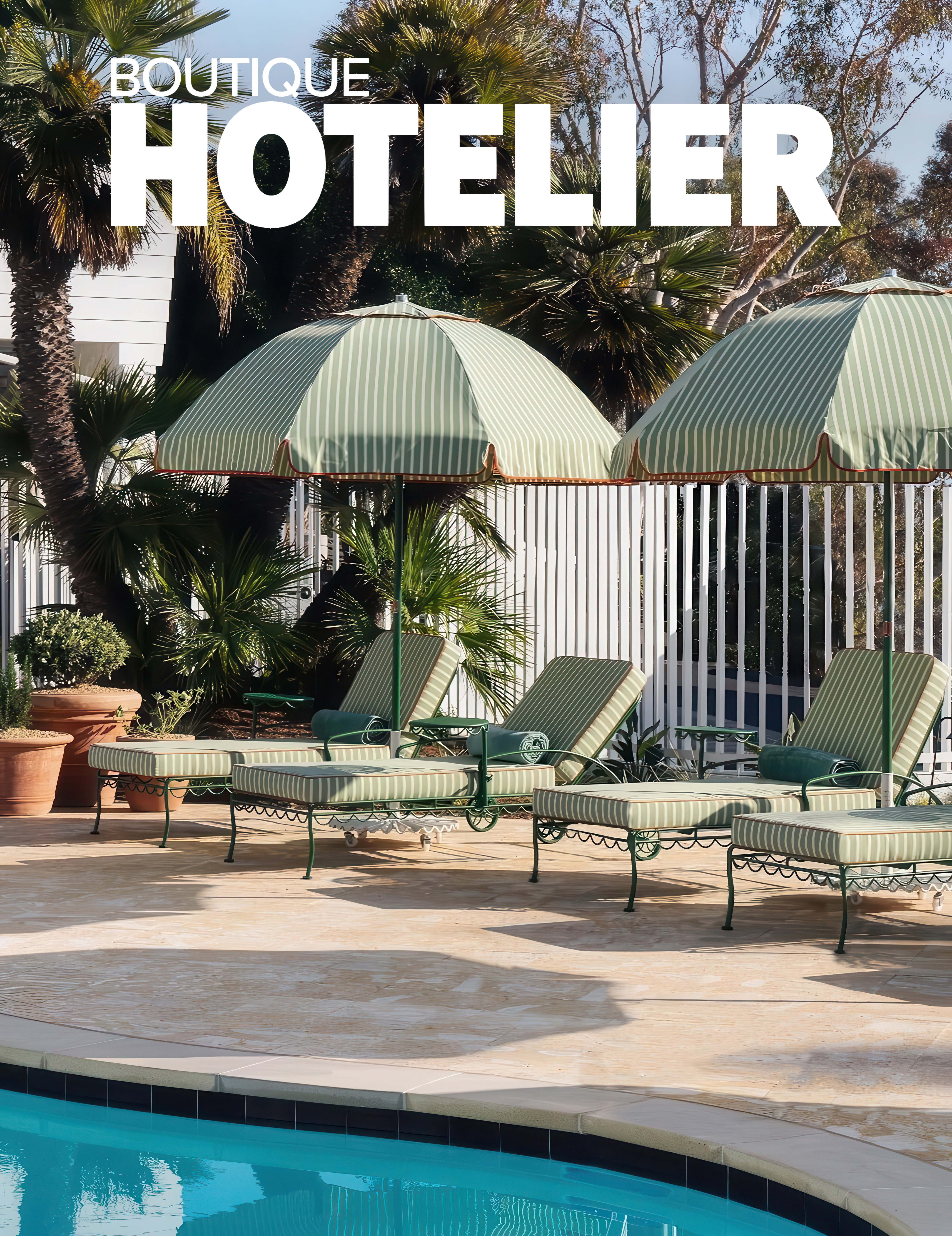 Boutique hotel pool with lounge chairs on a sunny day under green umbrellas