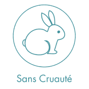 A woman lying down with a towel wrapped around her head, her face glistening with facial oil. Her eyes are closed, and she appears to be enjoying a spa treatment in a peaceful setting.