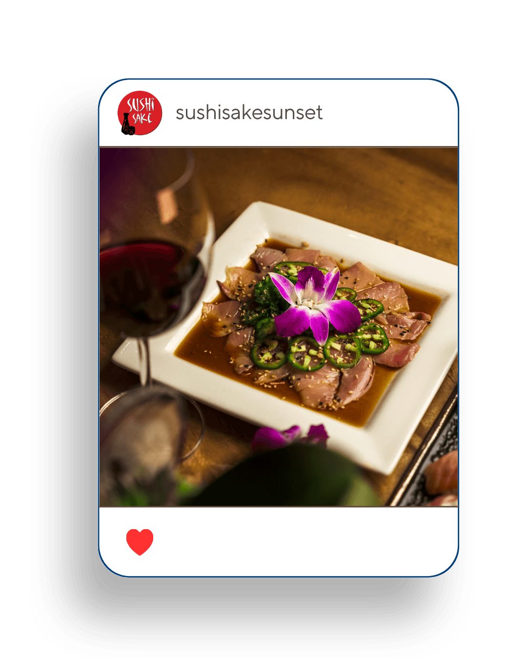 Three individuals gathered around a table, engaged in discussion while examining a laptop.