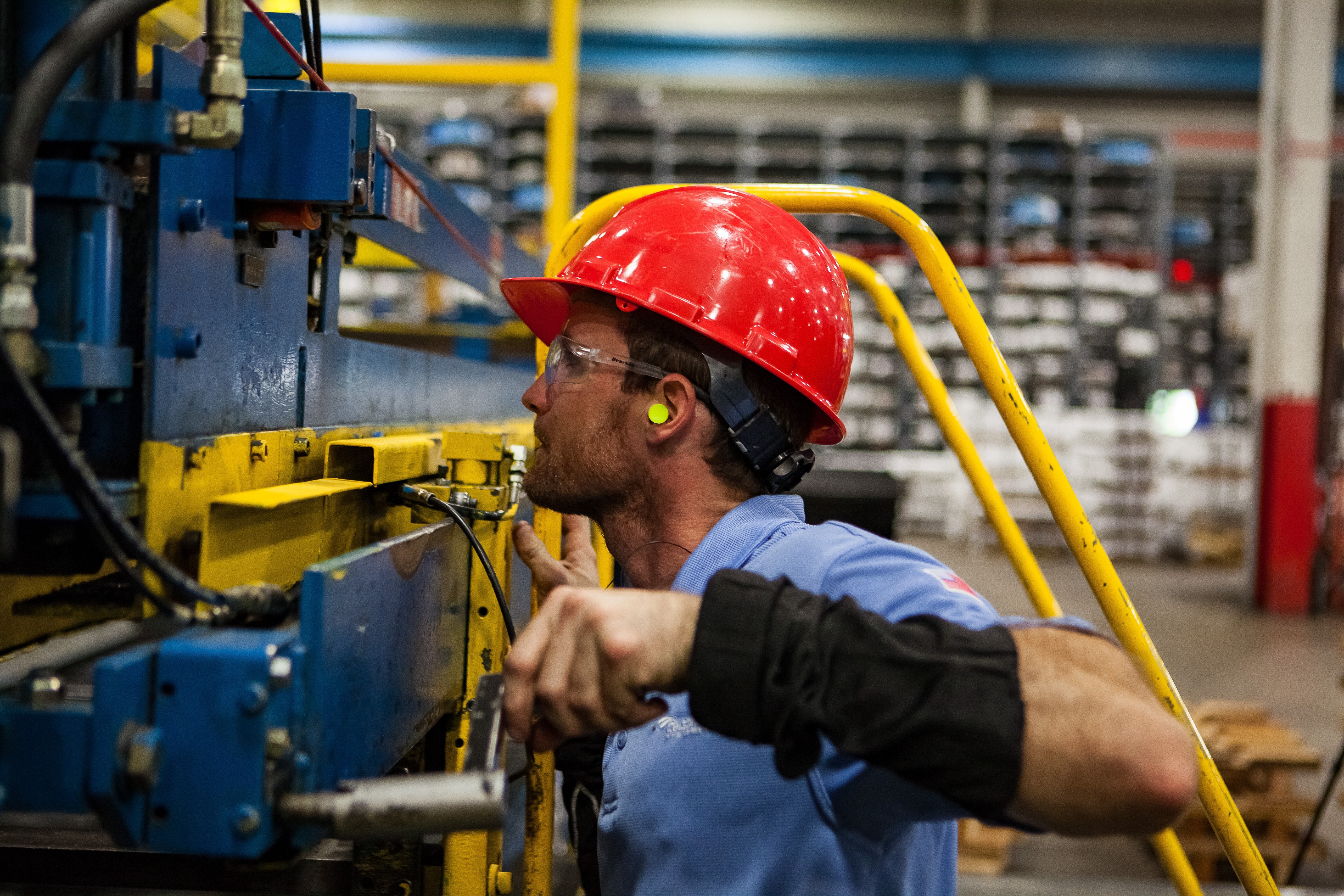 Maintenance technician performing routine inspection on industrial machinery