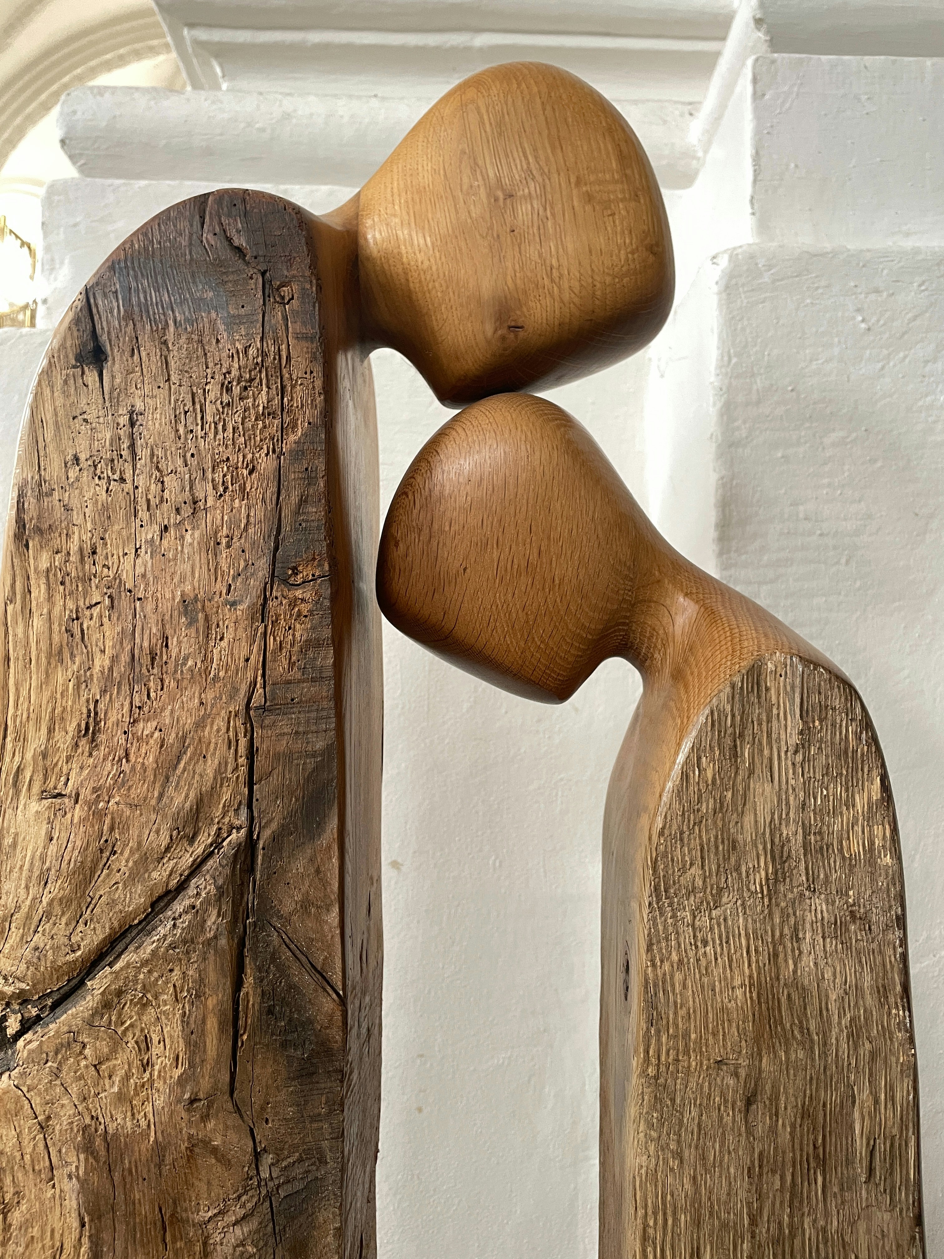 A couple of wooden sculptures sitting next to each other