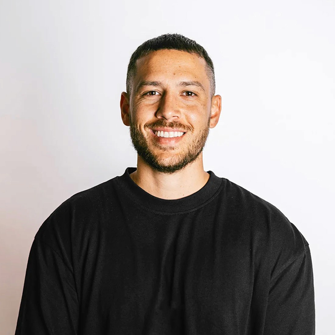 headshot of male in dark background