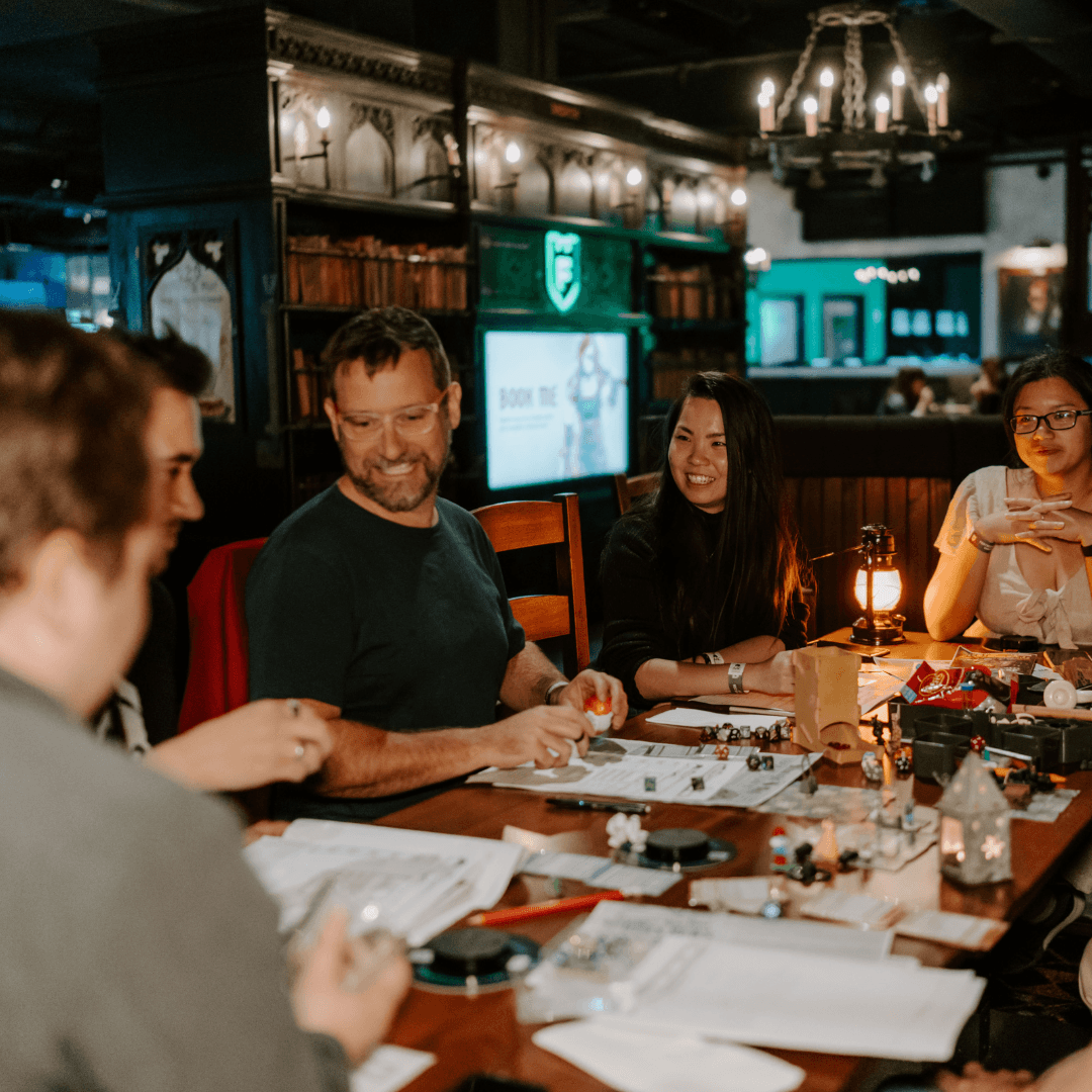 group of friends playing dungeons and dragons and laughing