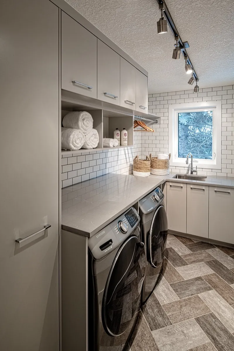 Image of Modern laundry room design with washer, dryer, sink, and built-in storage by KHD Homes.