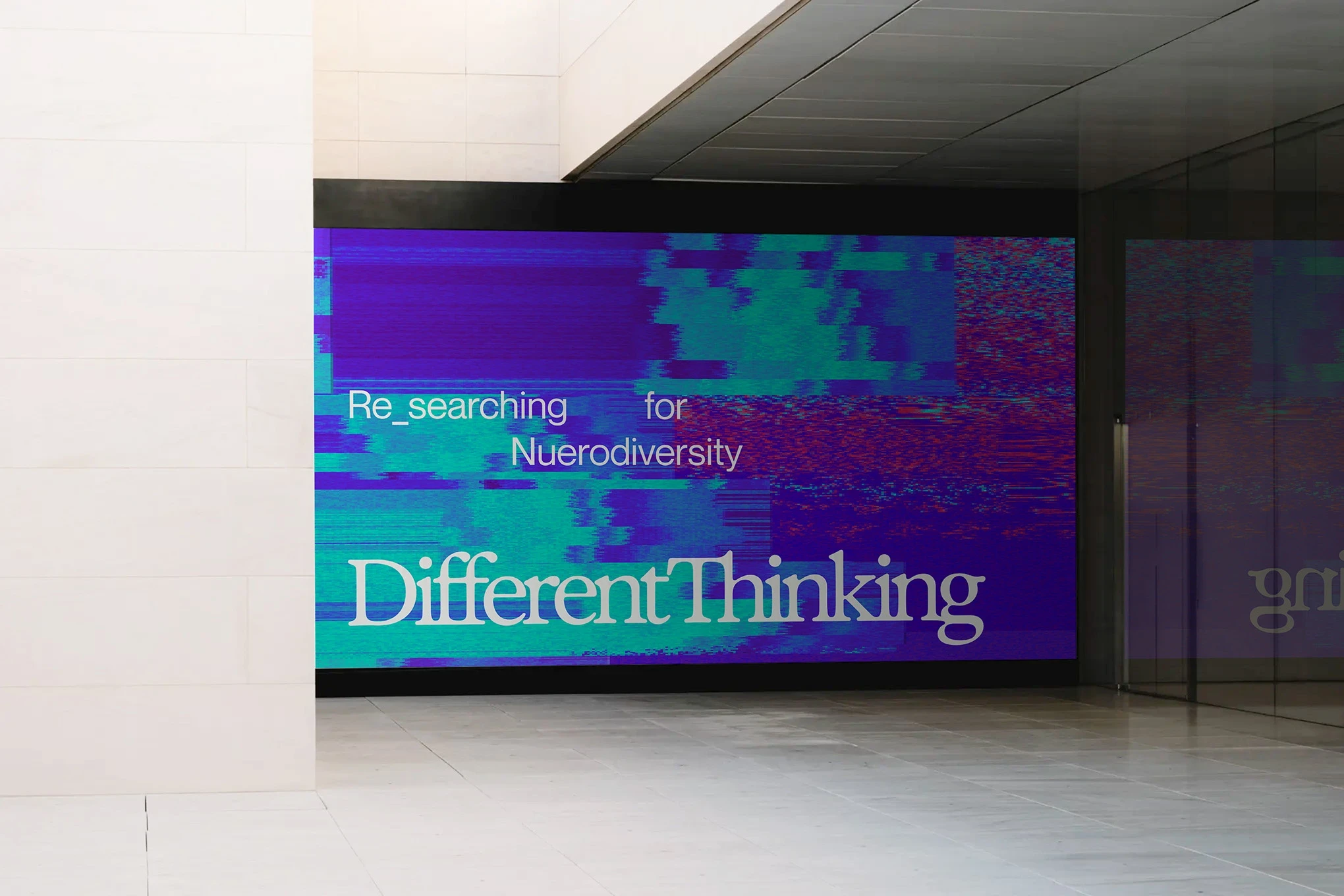 Different Thinking Re_searching for Neurodiversity digital billboard in a building lobby