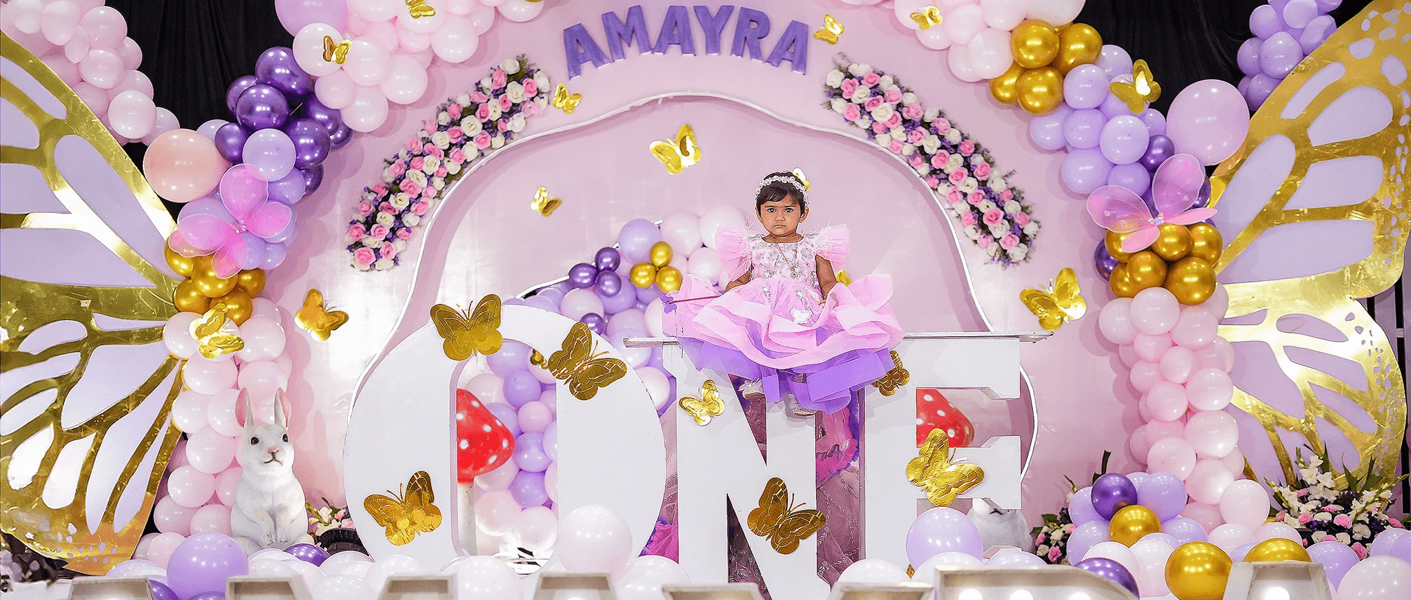 Full moon visible through silhouetted palm fronds at night.