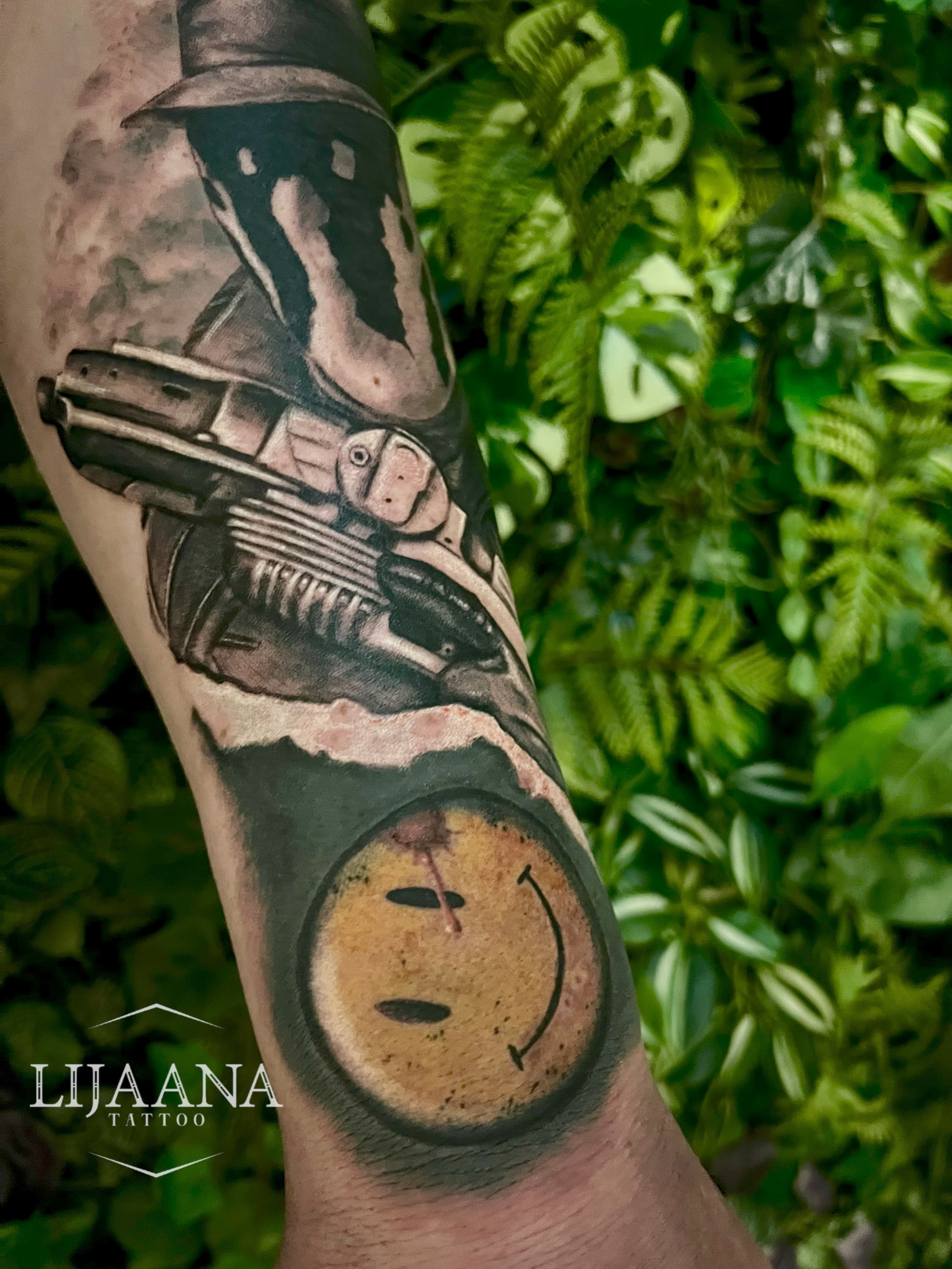 Realistic Watchmen tattoo featuring Rorschach and the iconic color smiley face badge in black and grey by Lijaana Tattoo in Helsinki.