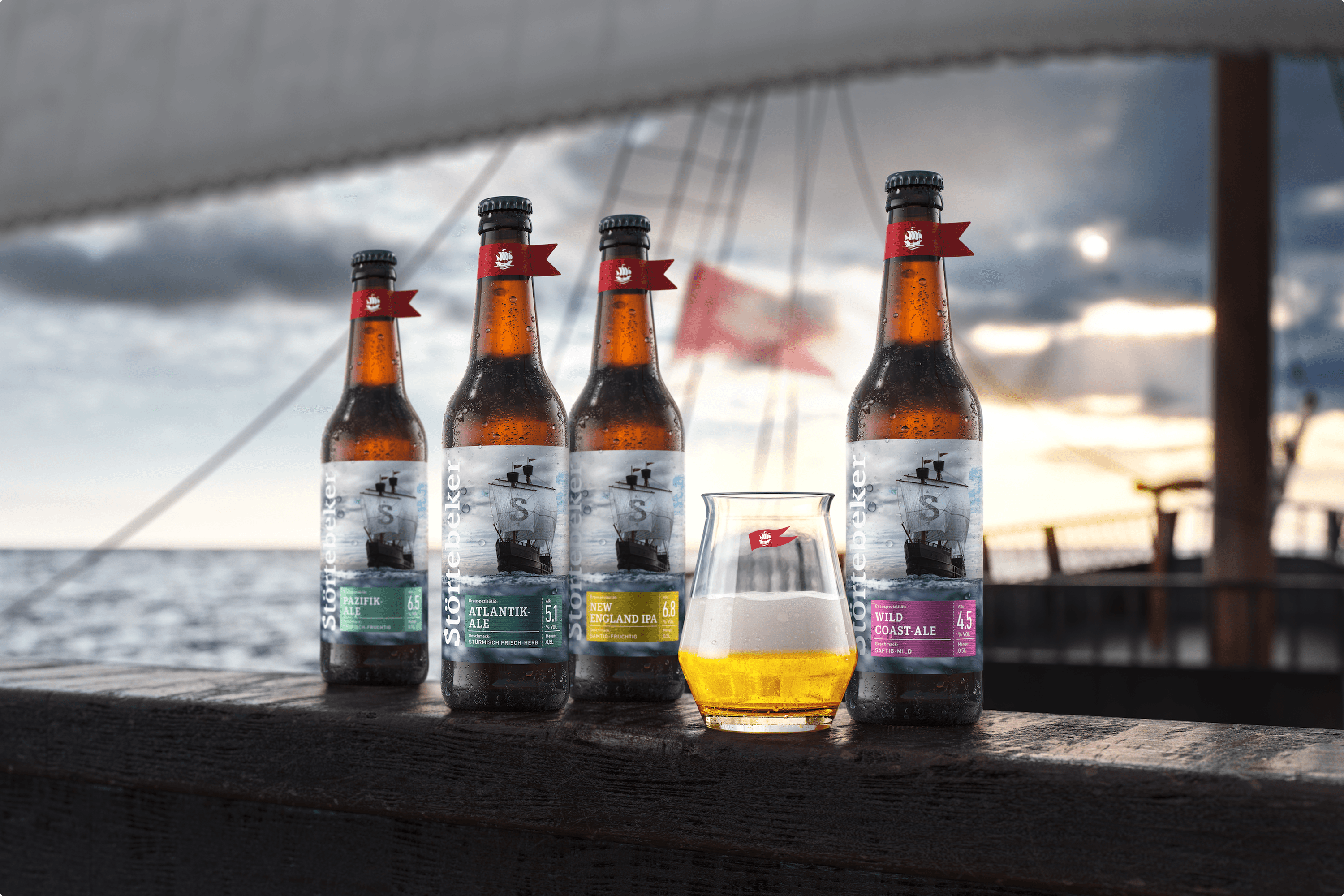 Four beer bottles and a glass on open deck with ship in background.