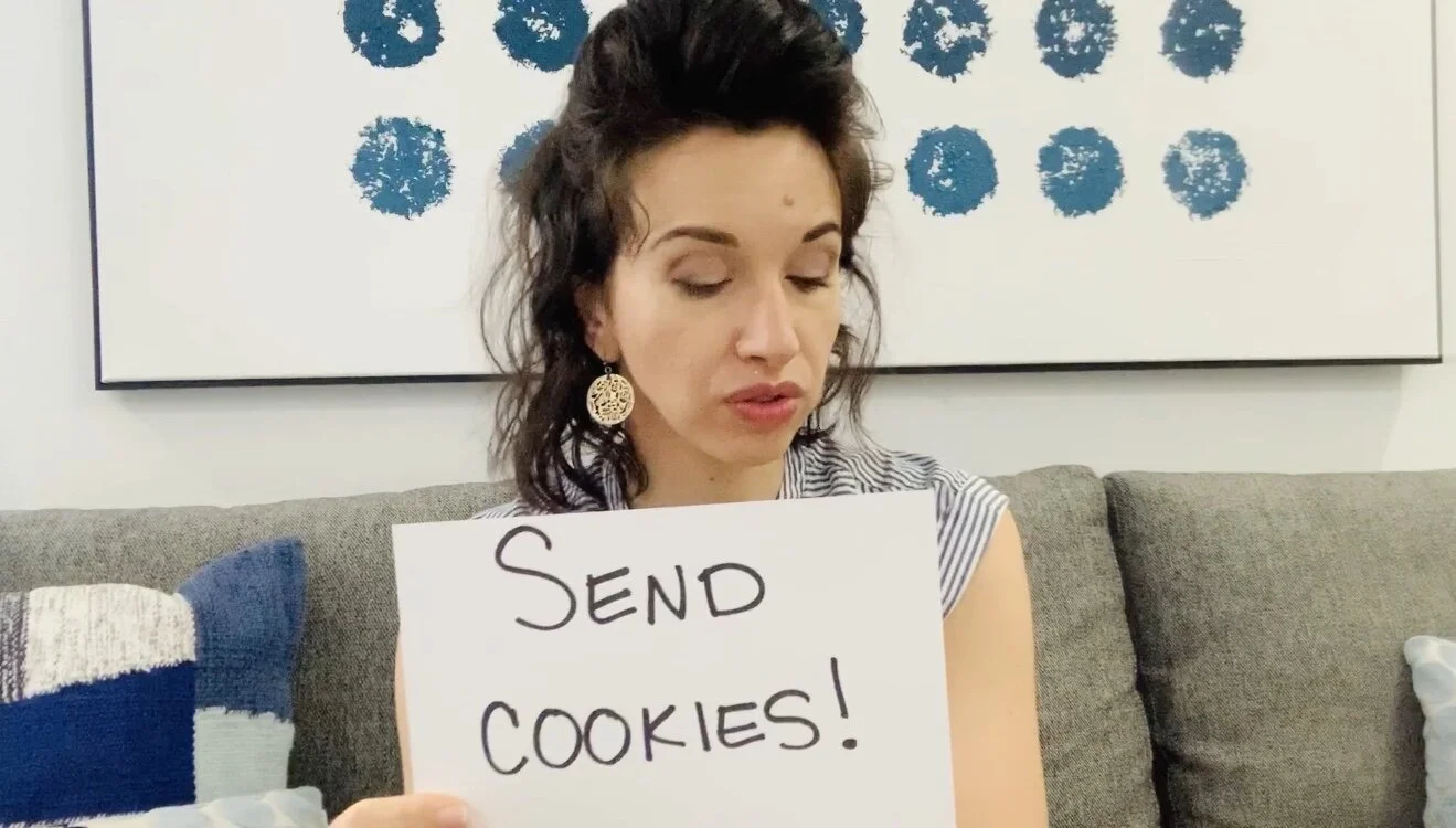 woman holding a send cookies sign