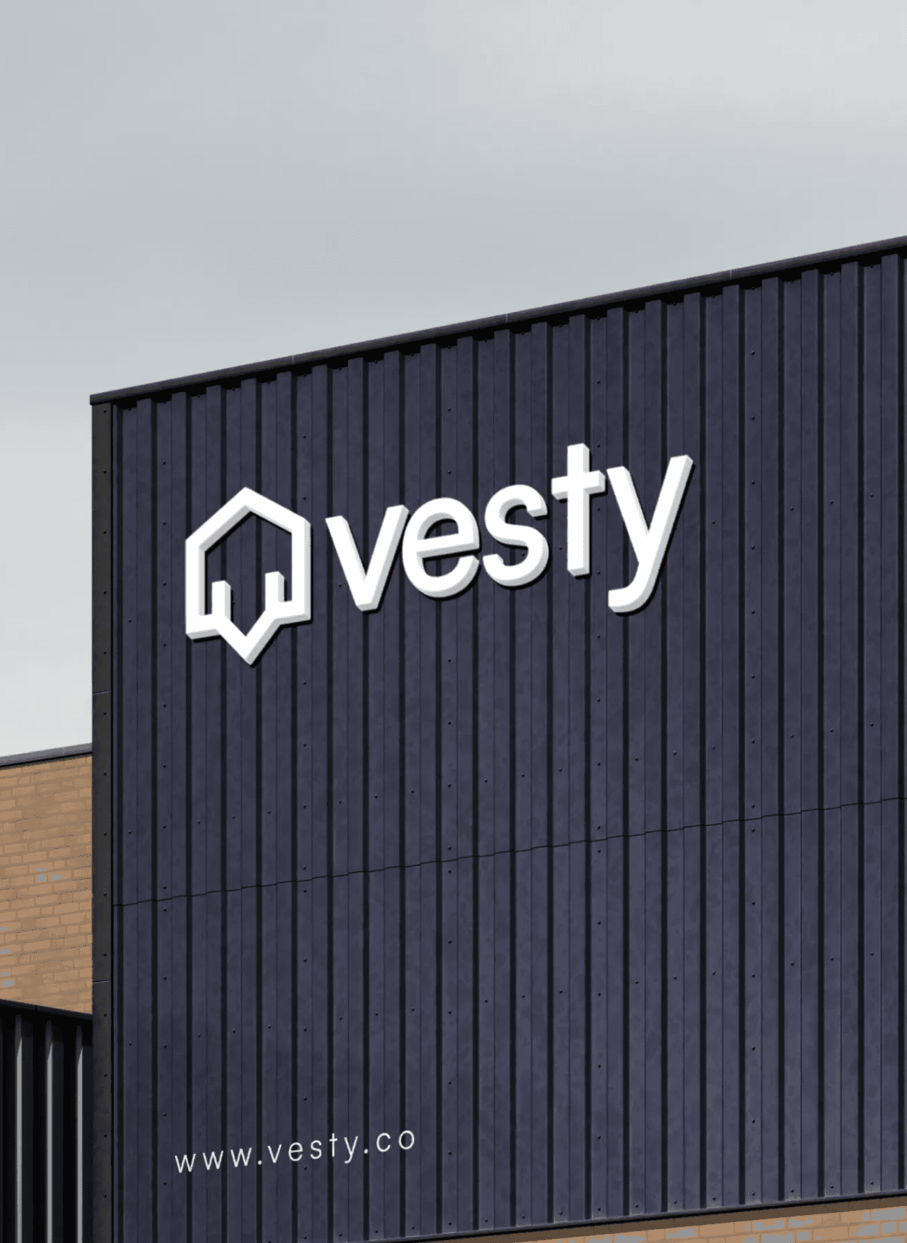 Modern building facade with 'vesty' logo and website URL in white on dark panels