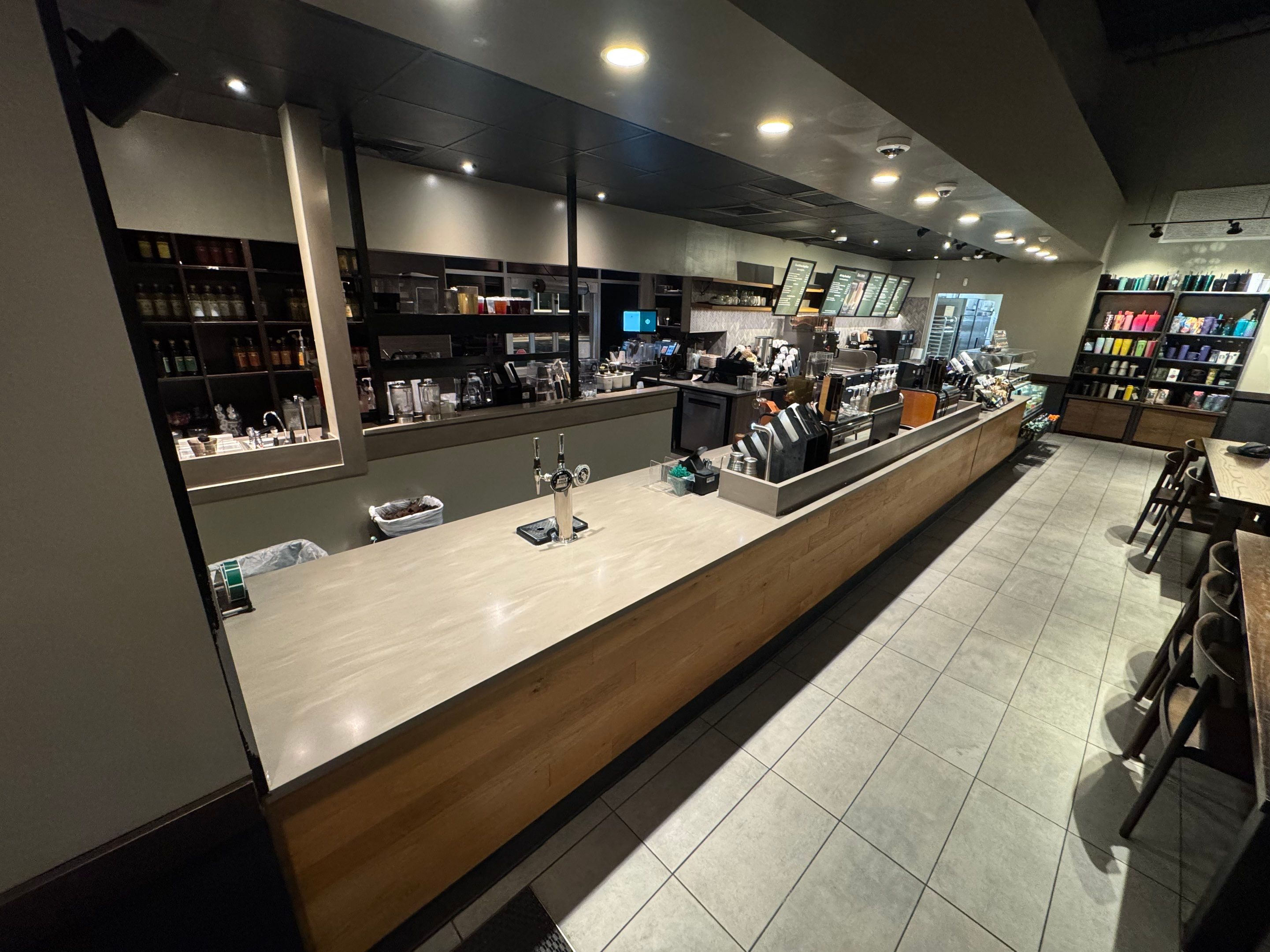 Newly replaced Starbucks countertop with reinforced support and smooth epoxy finish, showcasing clean installation across the bar and prep area.