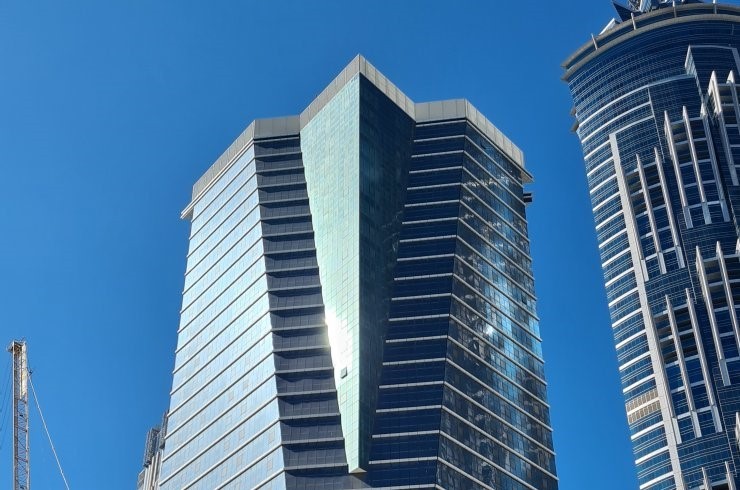 Court Tower's unique glass facade in Dubai, highlighted by a dedicated real estate professional.