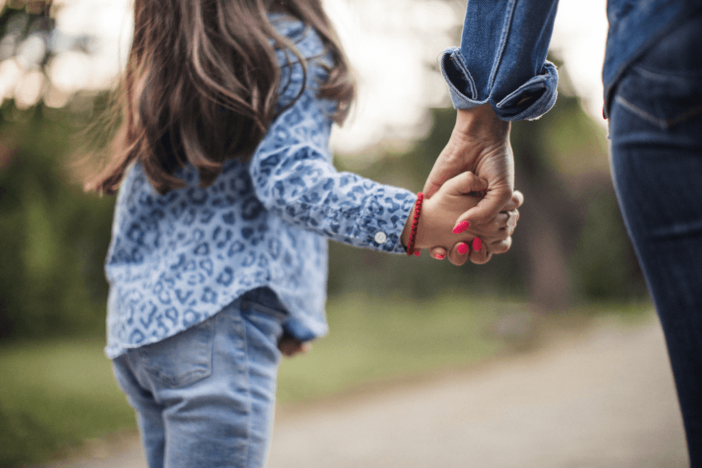 Child holding mother's hand