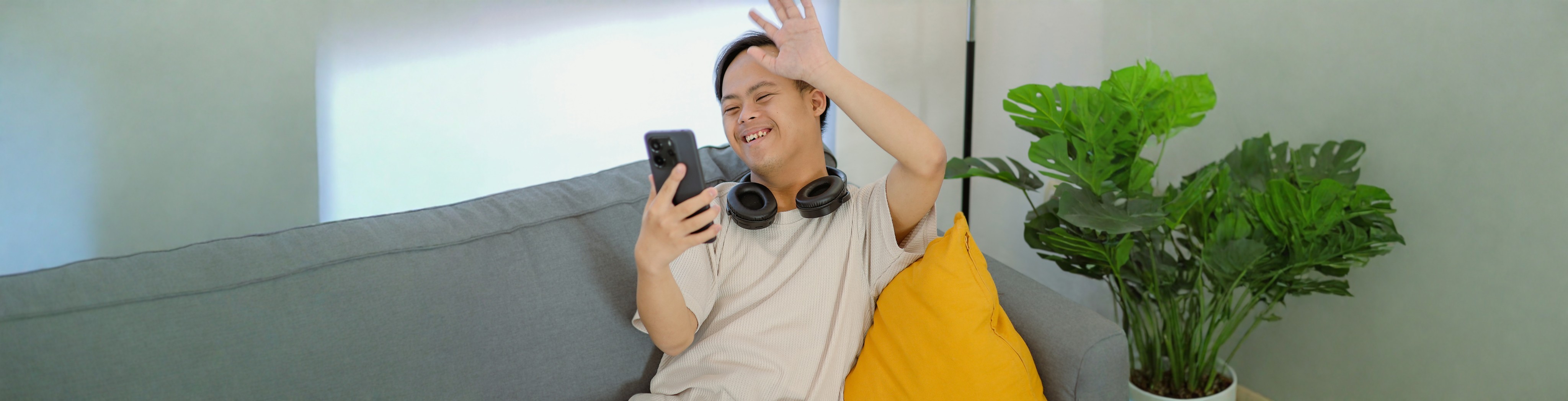 man on phone waving to the contact team