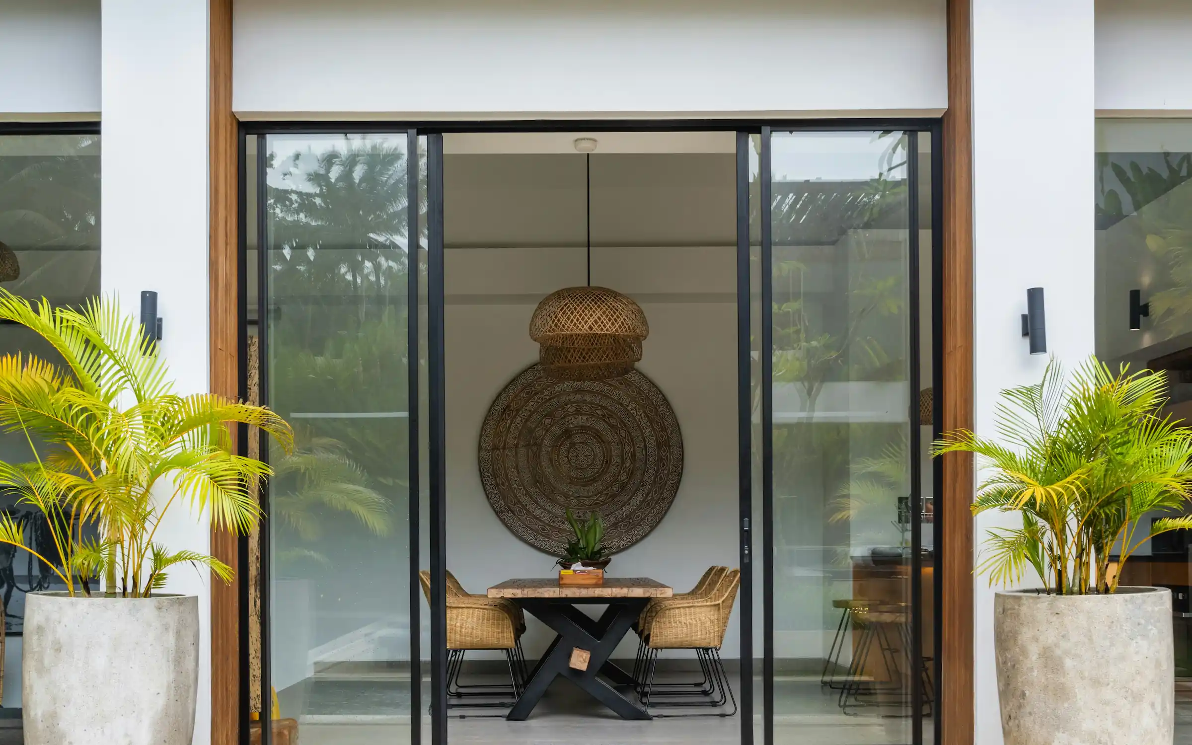 Modern interior entrance with floor-to-ceiling glass walls and warm timber cladding overlooking landscape