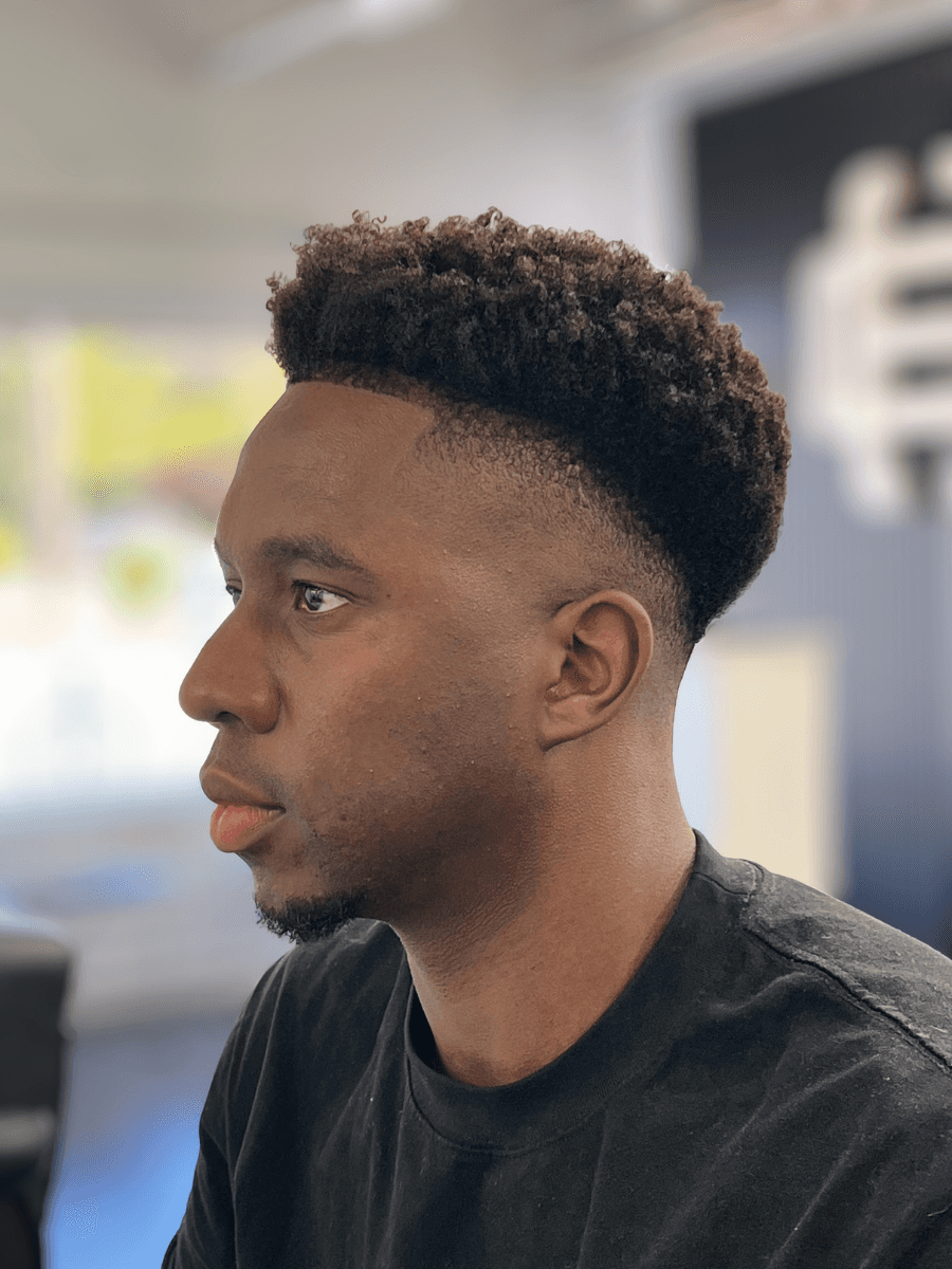 a woman cutting another woman's hair with scissors