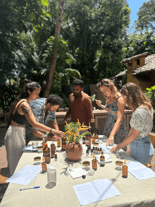 a group of women standing on top of a sandy beach