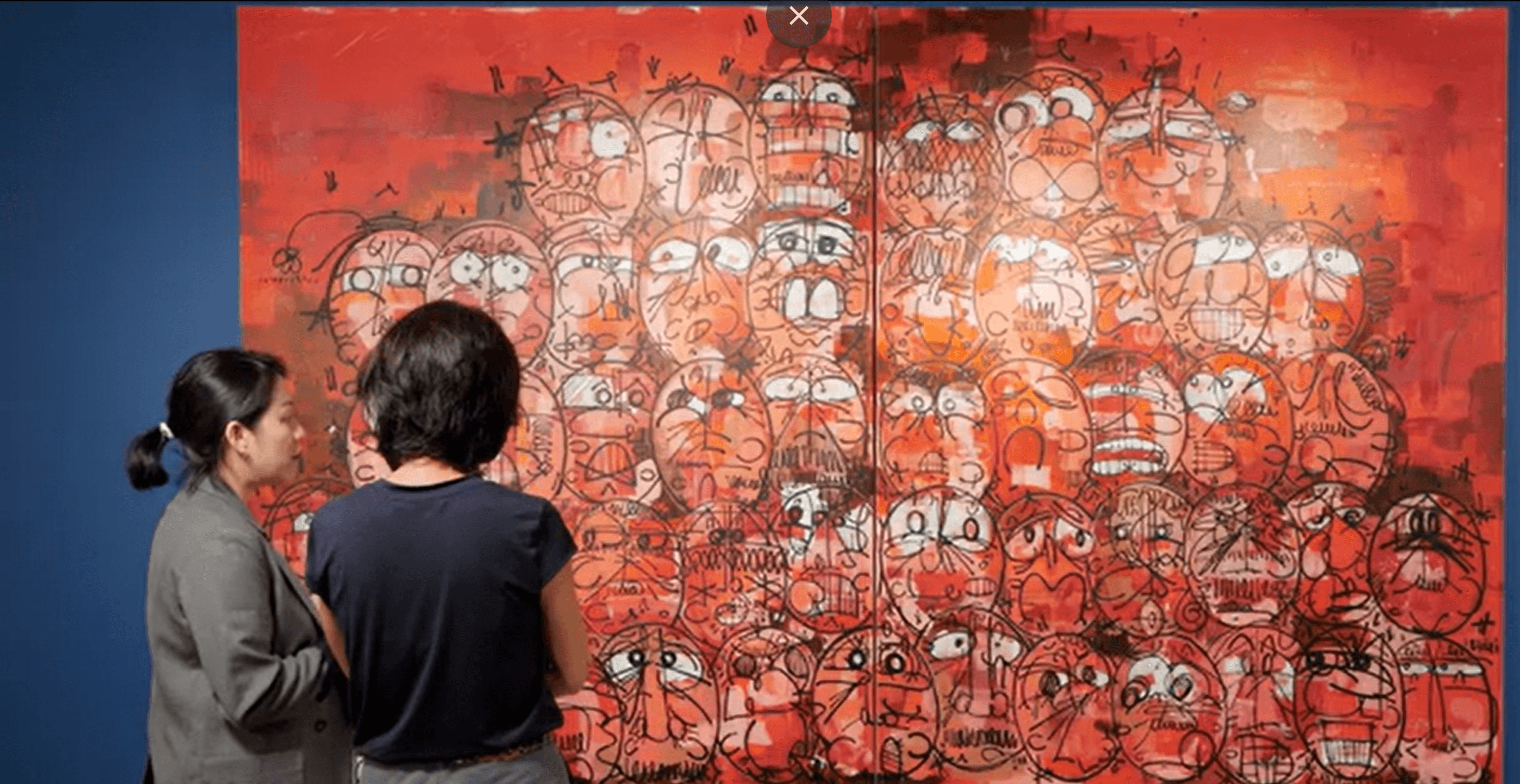 man in black polo shirt wearing white mask holding black camera