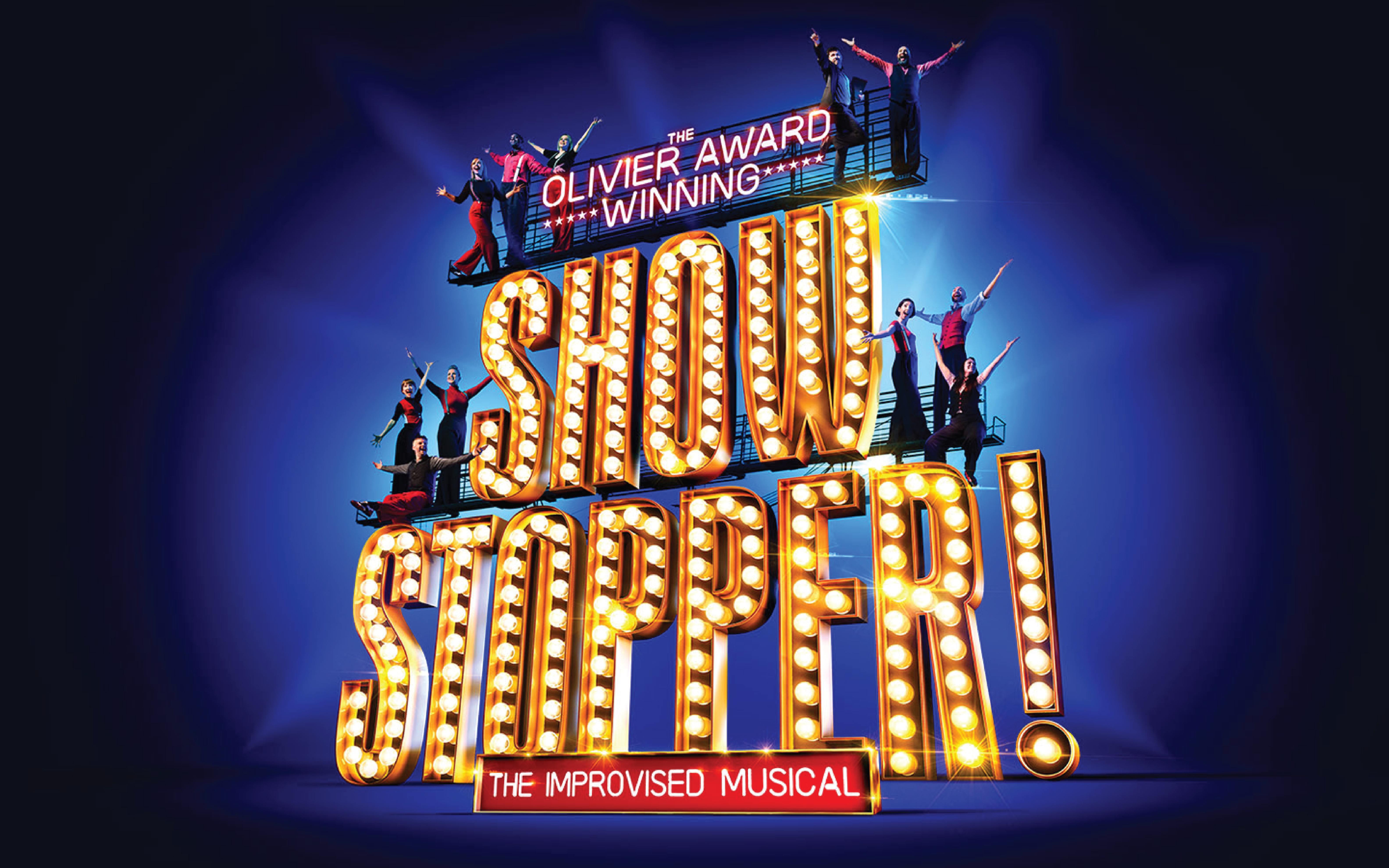 Showstopper! The Improvised Musical sign with performers on stage.