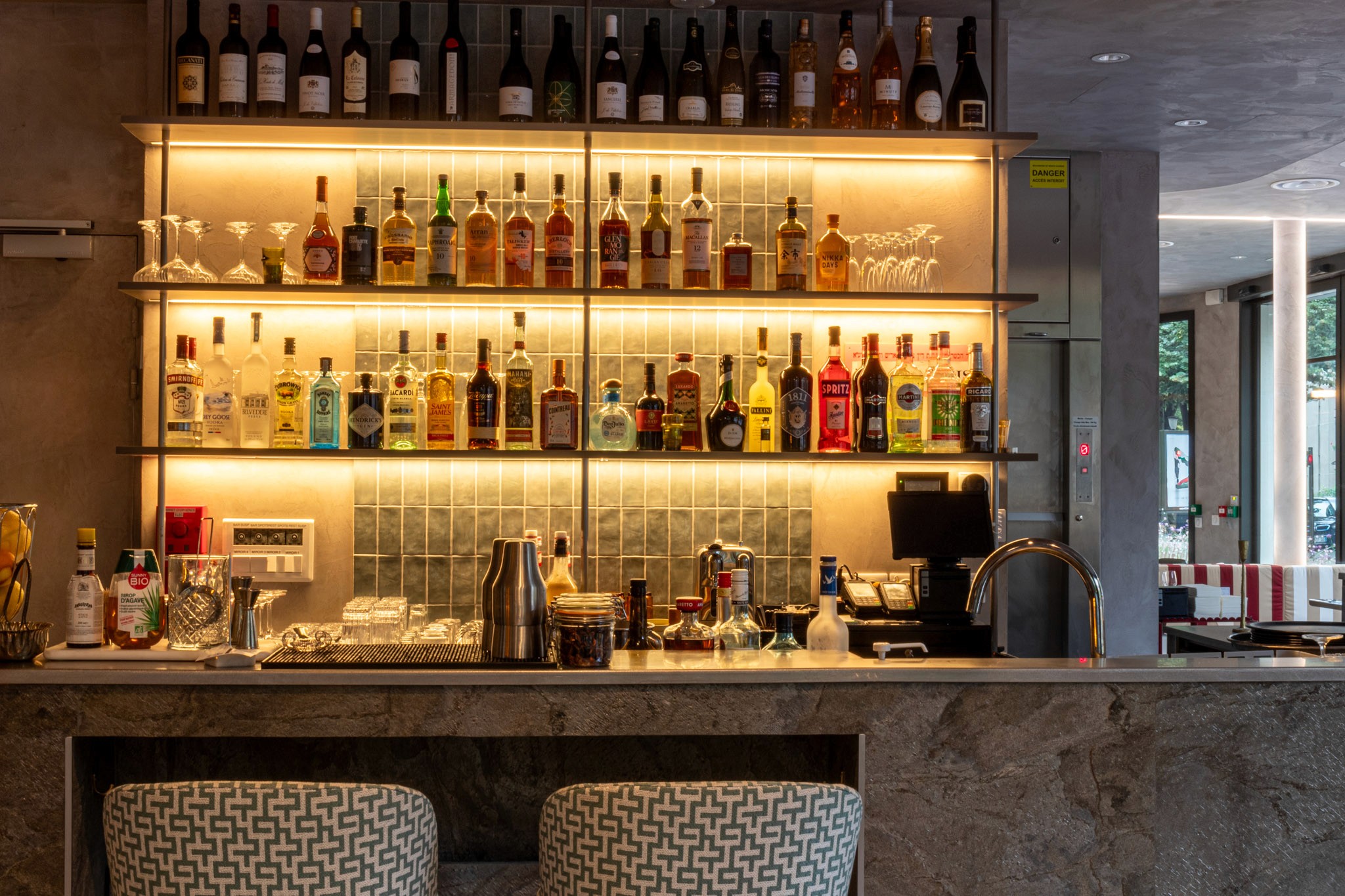 Bright living room with arched windows, white sofas, teal accents, and a cozy, modern design featuring natural light and greenery.