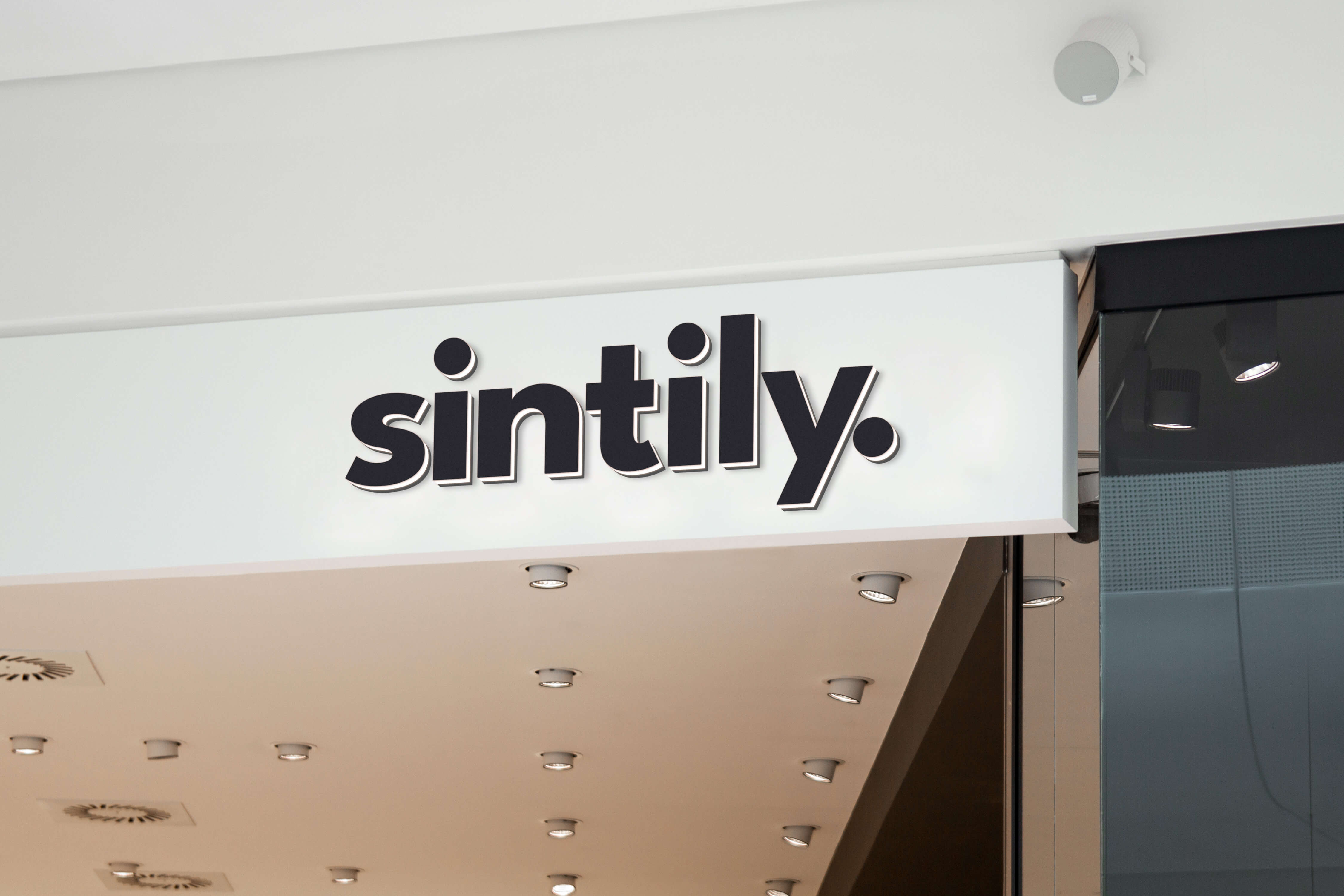 Two men discuss a project while standing at a laptop in an office.