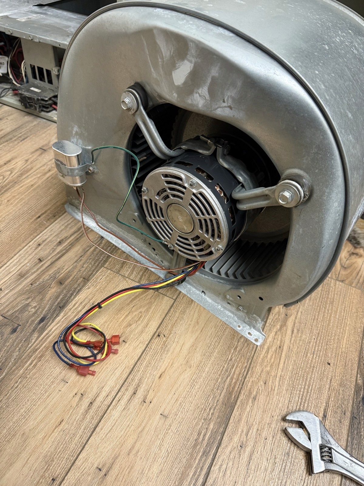 Blower assembly with a new OEM motor installed during a commercial AC repair.