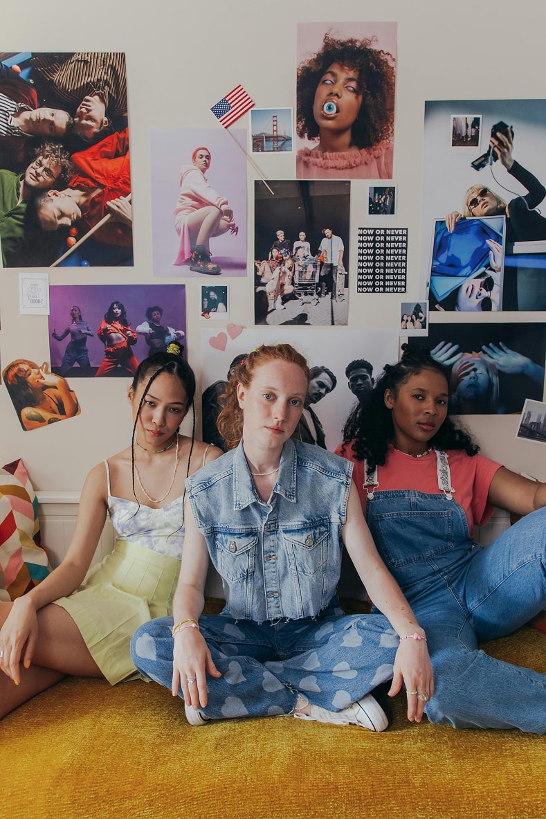 woman holding camera standing on beach