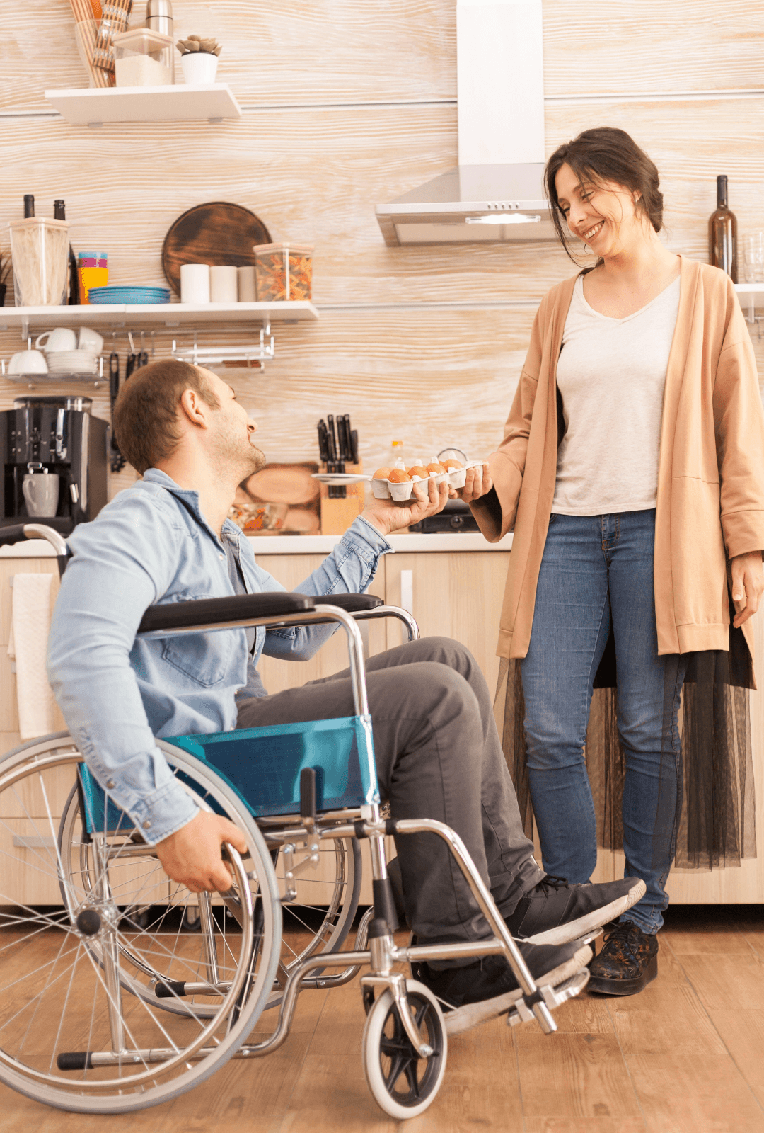 A female caregiver helping a man with disability who's sitted on a wheelchair - Funado care services DD suport