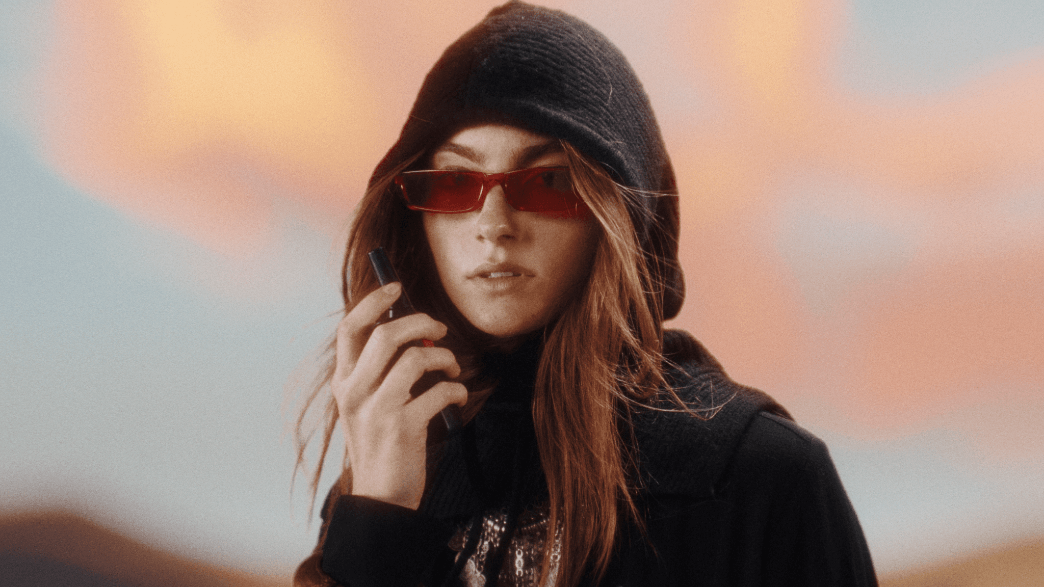 Bold editorial fashion portrait of model in houndstooth blazer with red tie and green shirt against bright turquoise background - Serif Creative Studio luxury fashion photography