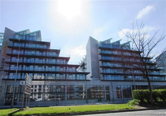 Seskin Apartments – A glass-fronted, high-rise apartment building.