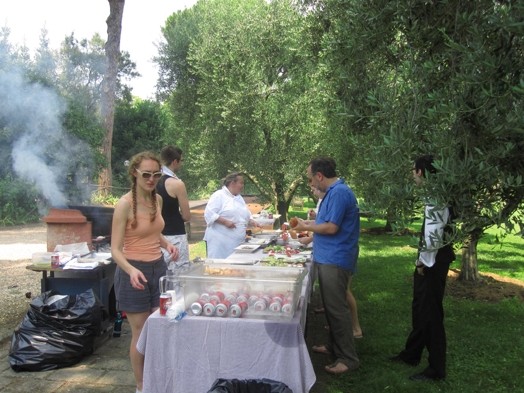 A photo of a group of people having a snack in the garden.