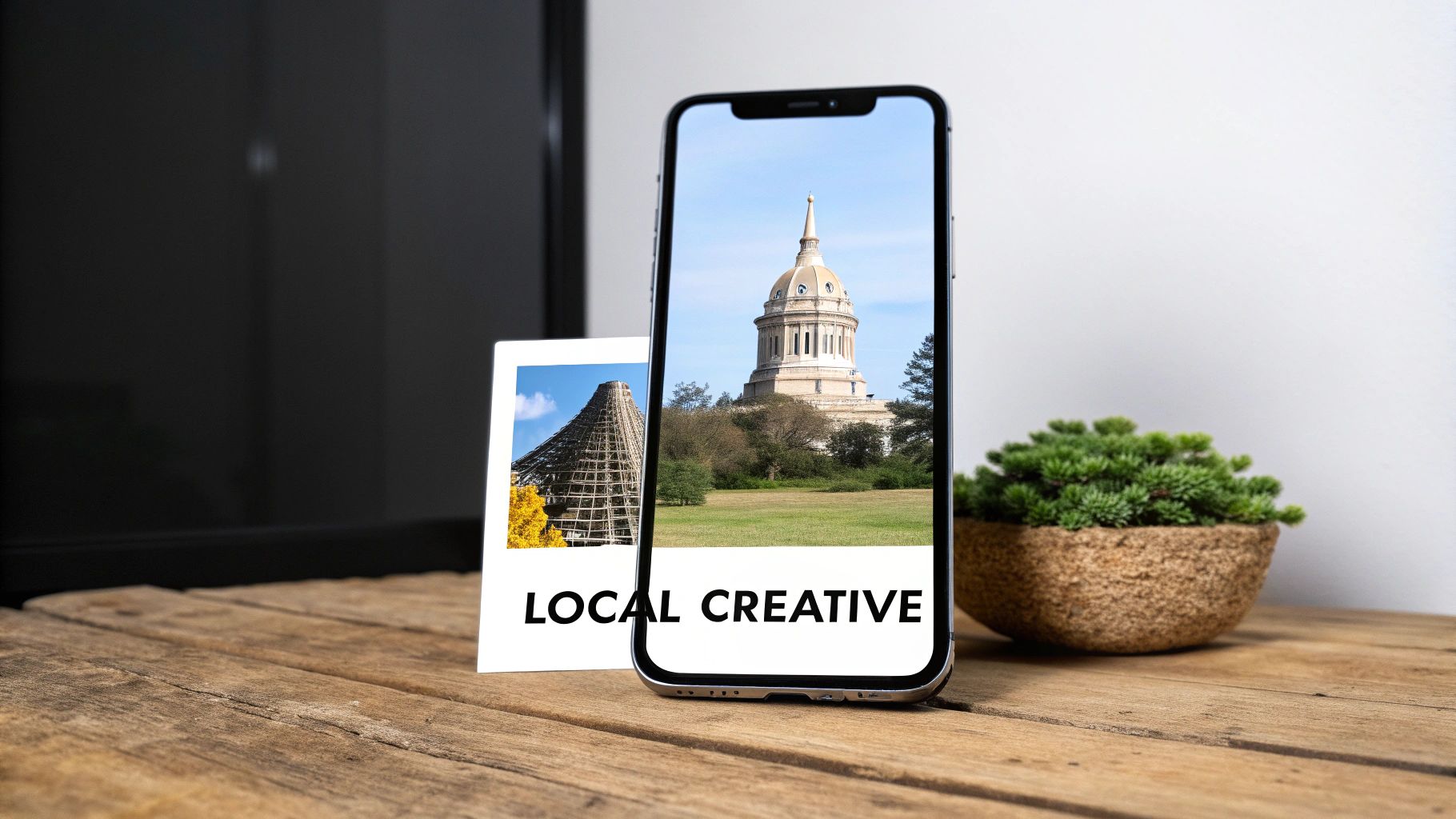 A smartphone displaying a domed building, a polaroid with a pyramid and