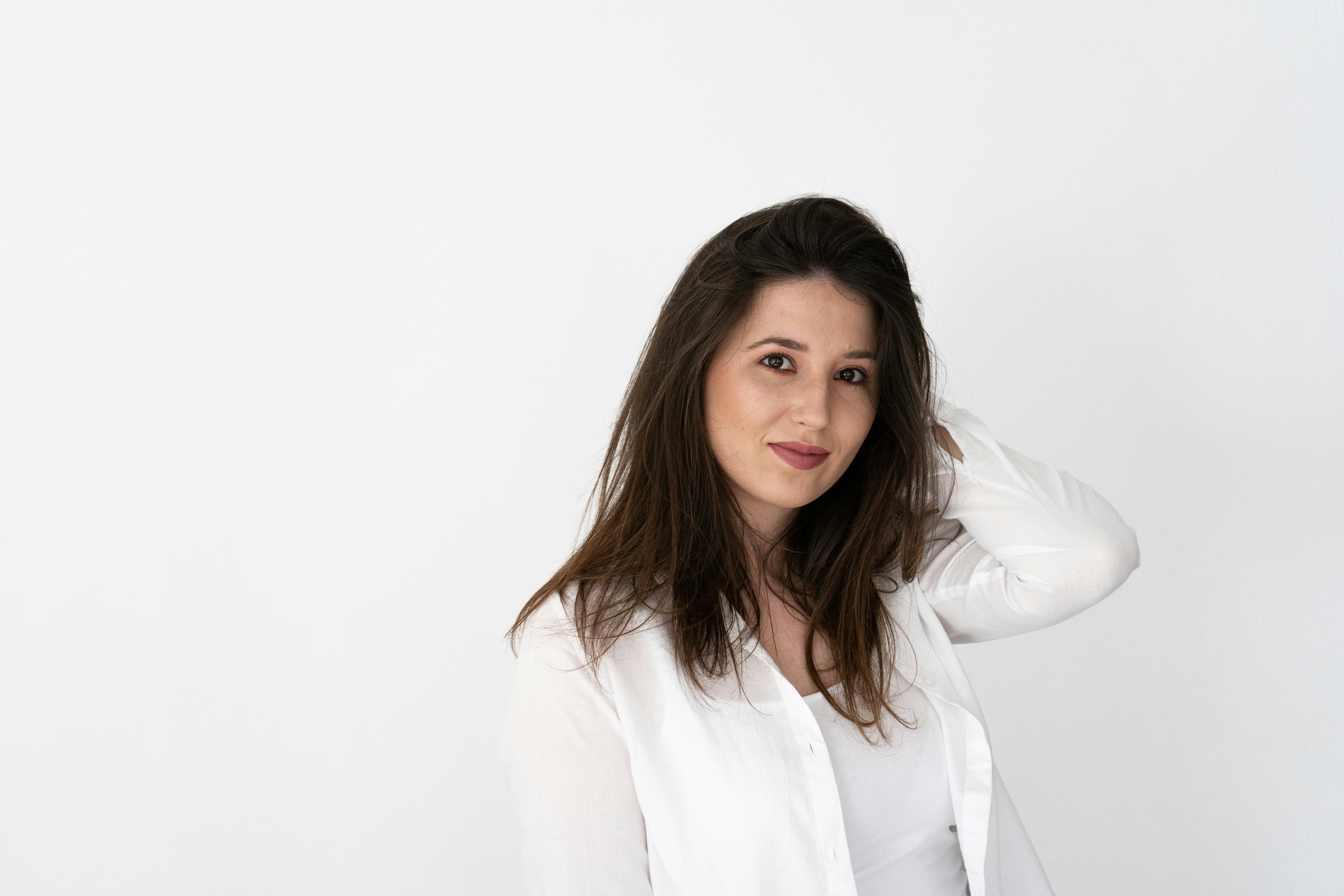 a woman in a white shirt is posing for a picture