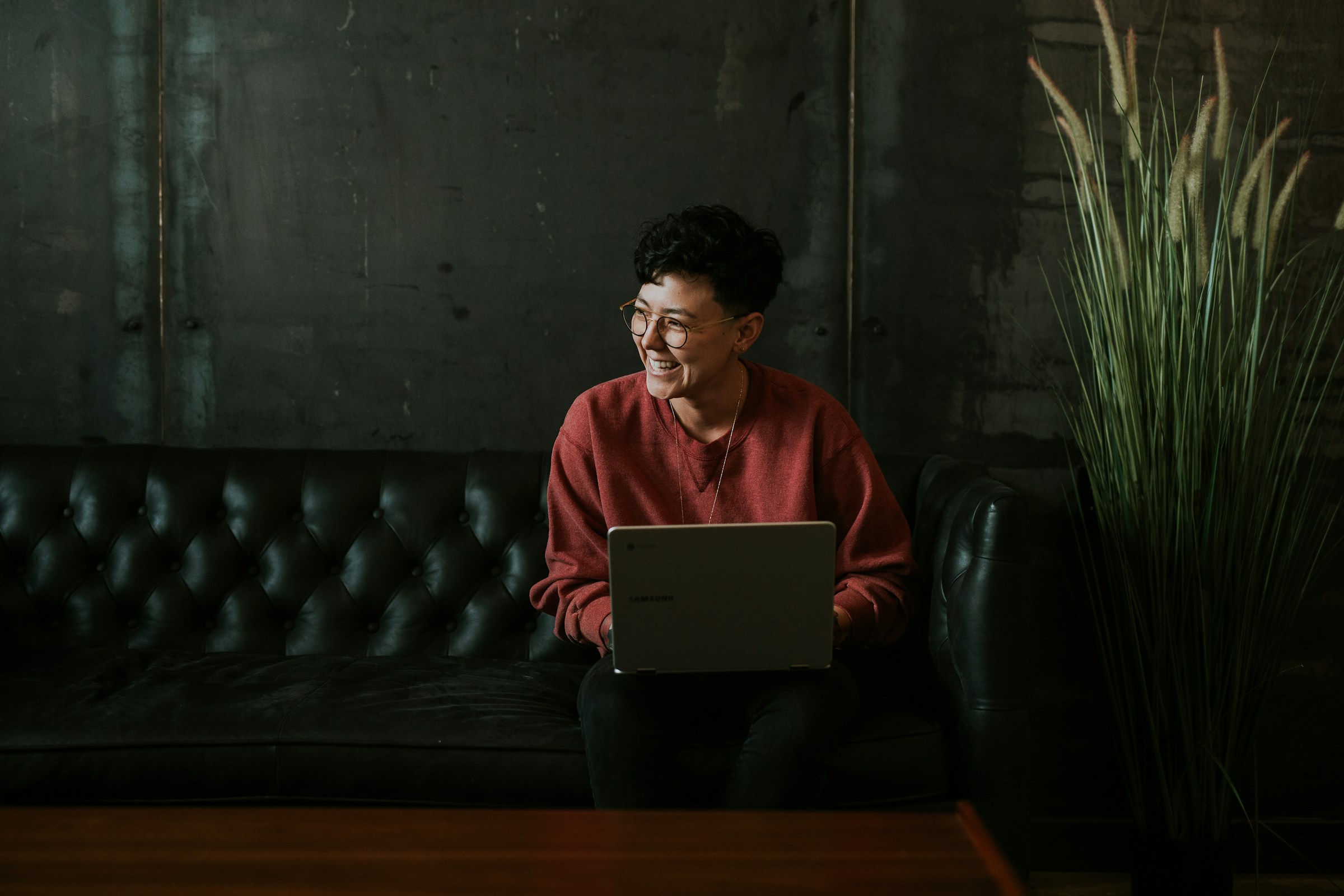 woman smiling while working - How To Make ChatGPT Sound Human