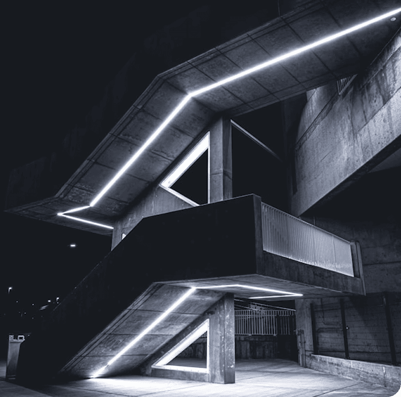 Stylistic photograph of a night staircase illuminated with white neon lights and square shapes