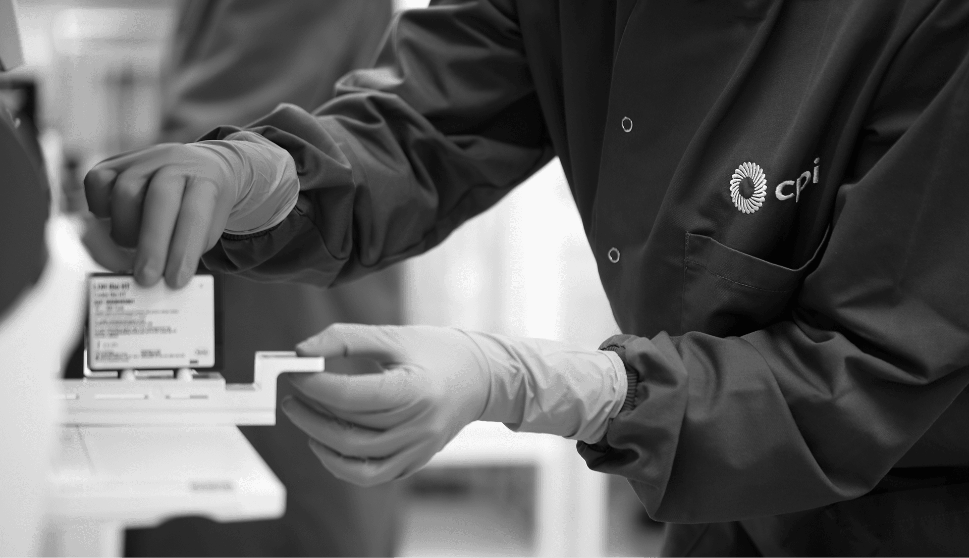 A photo of a lab technician working in the lab