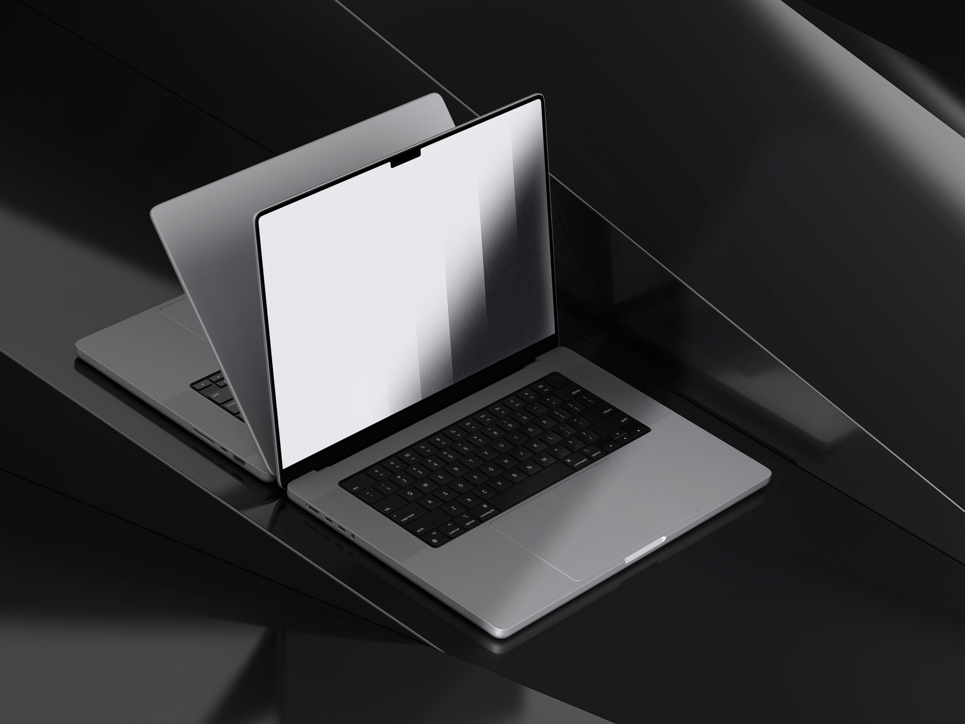 Two sleek, modern laptops with open screens and black keyboards rest on a glossy black surface, showcasing minimalist and sophisticated technology design.