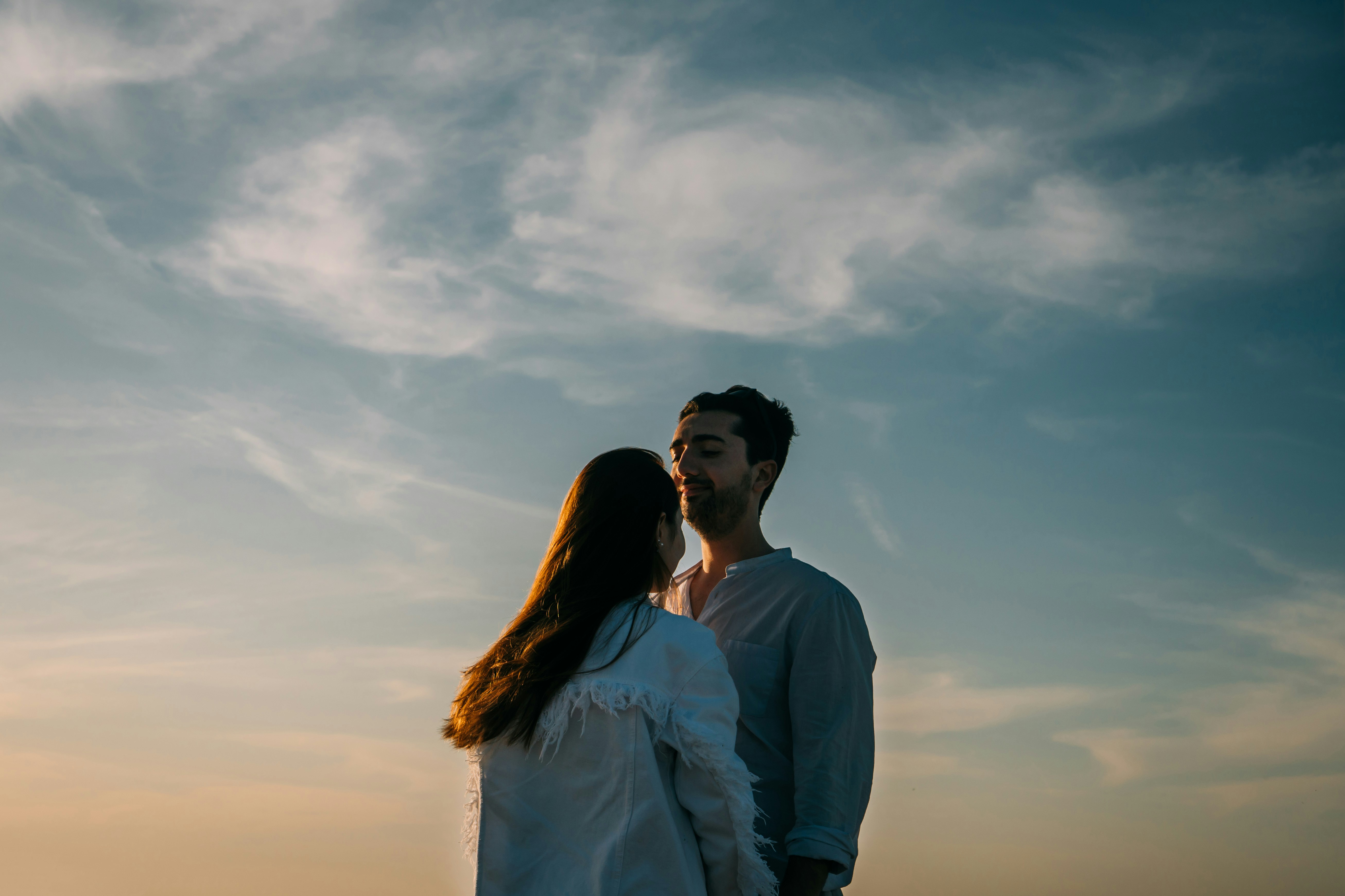 man in white dress shirt standing beside woman in white dress shirt