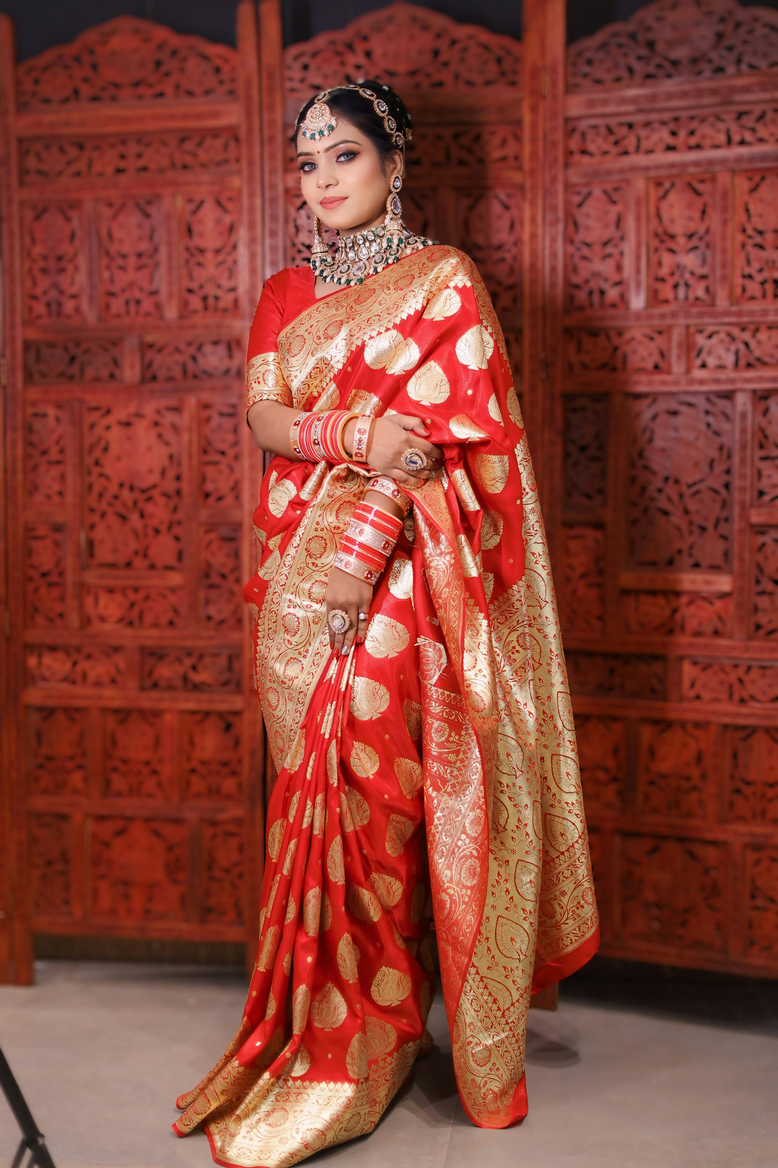 a woman in a red and gold sari