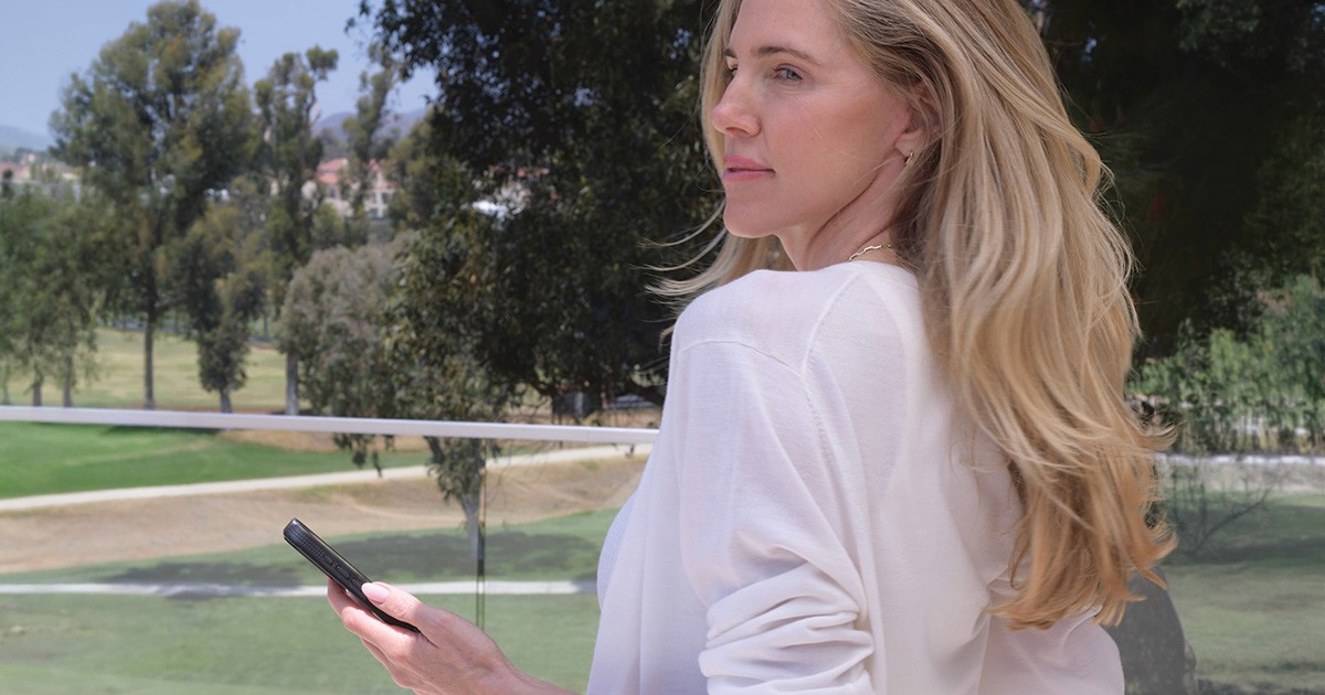 Woman using her smartphone for a daily emotional check-in with the app Reset with Thea.