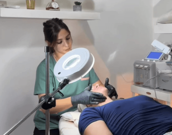 A luxurious indoor spa area with a pool, lounge beds, and a breathtaking view of a city skyline at sunset. The golden lighting enhances the warm and tranquil atmosphere, creating a perfect relaxation retreat.