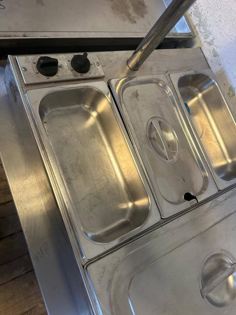 a group of people sitting at a table with a fire in the background