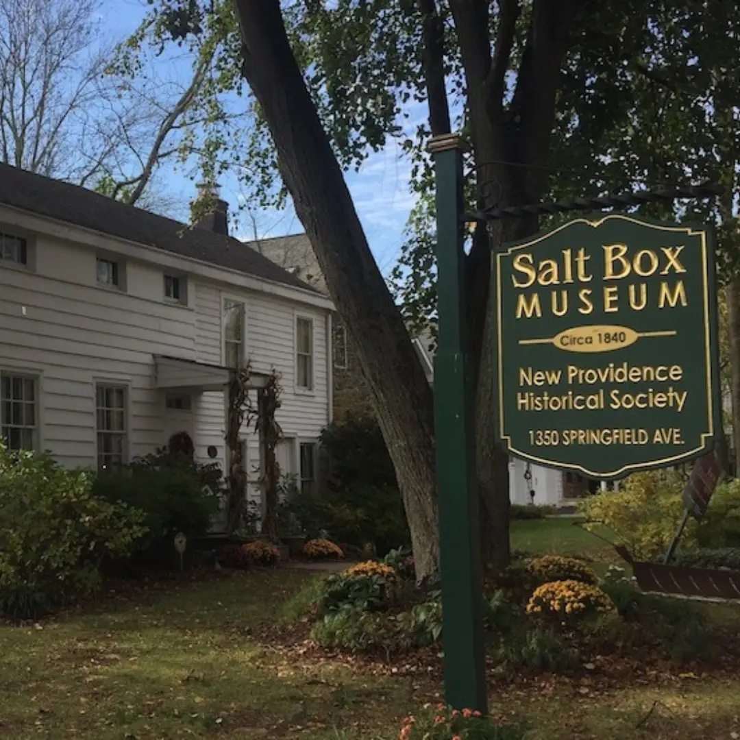 Salt Box Museum: A historic white house with its prominent sign.