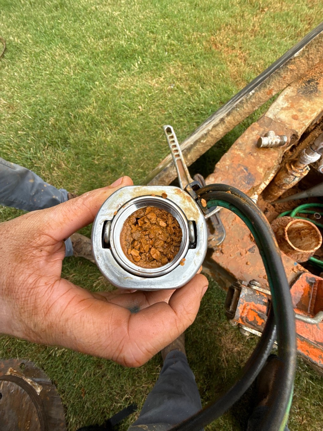 Submersible pump pulled from a Grapevine, TX well showing iron bacteria slime and rust buildup before chlorine shock and rehab