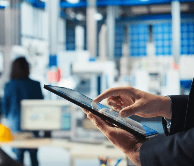 Person using a tablet to monitor building operations, representing digital facilities management through HoustonPlus.