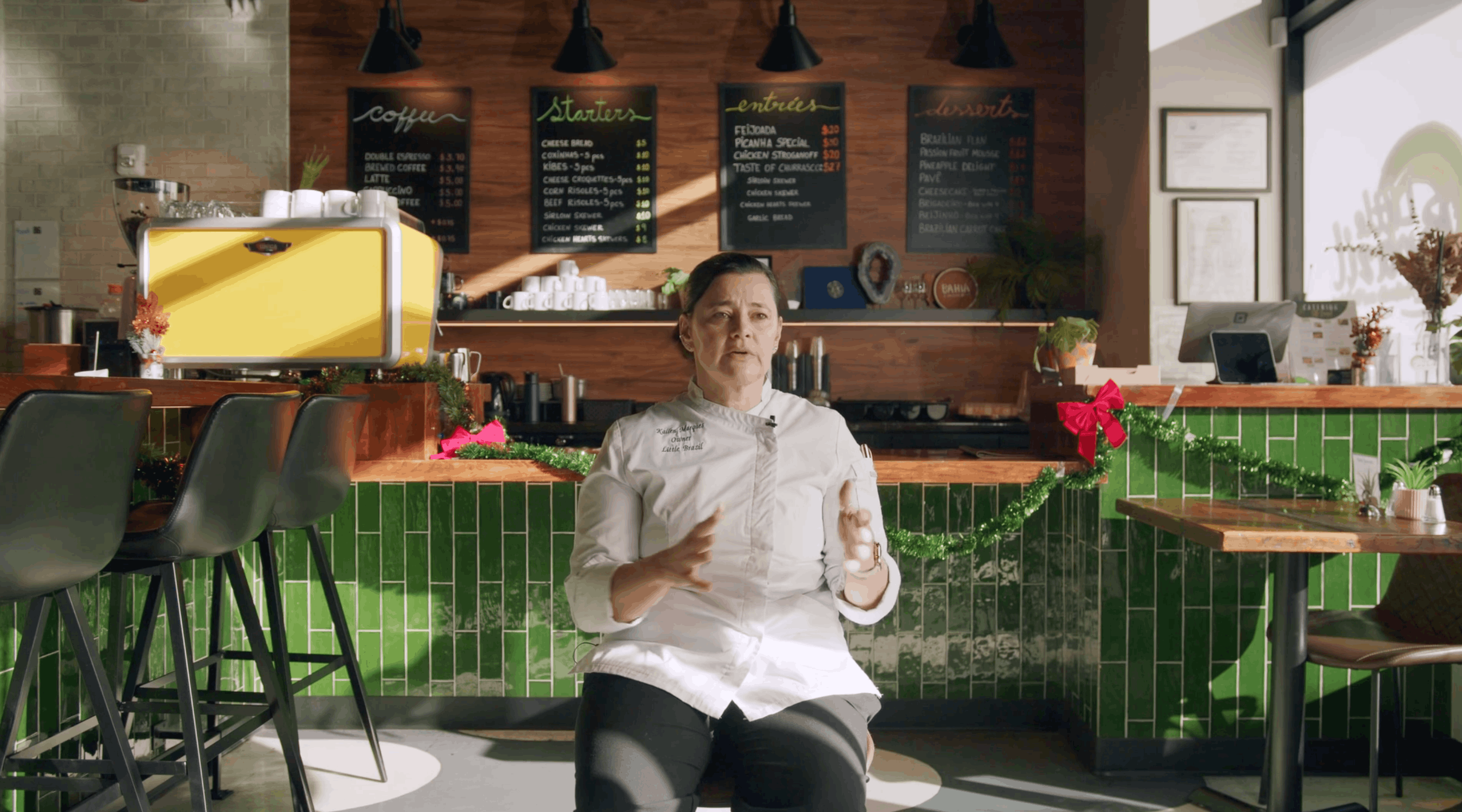 Restaurant owner seated in her space sharing a testimonial for DoorDash