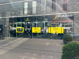 A modern building, with bright yellow Circle Fit markings visible.