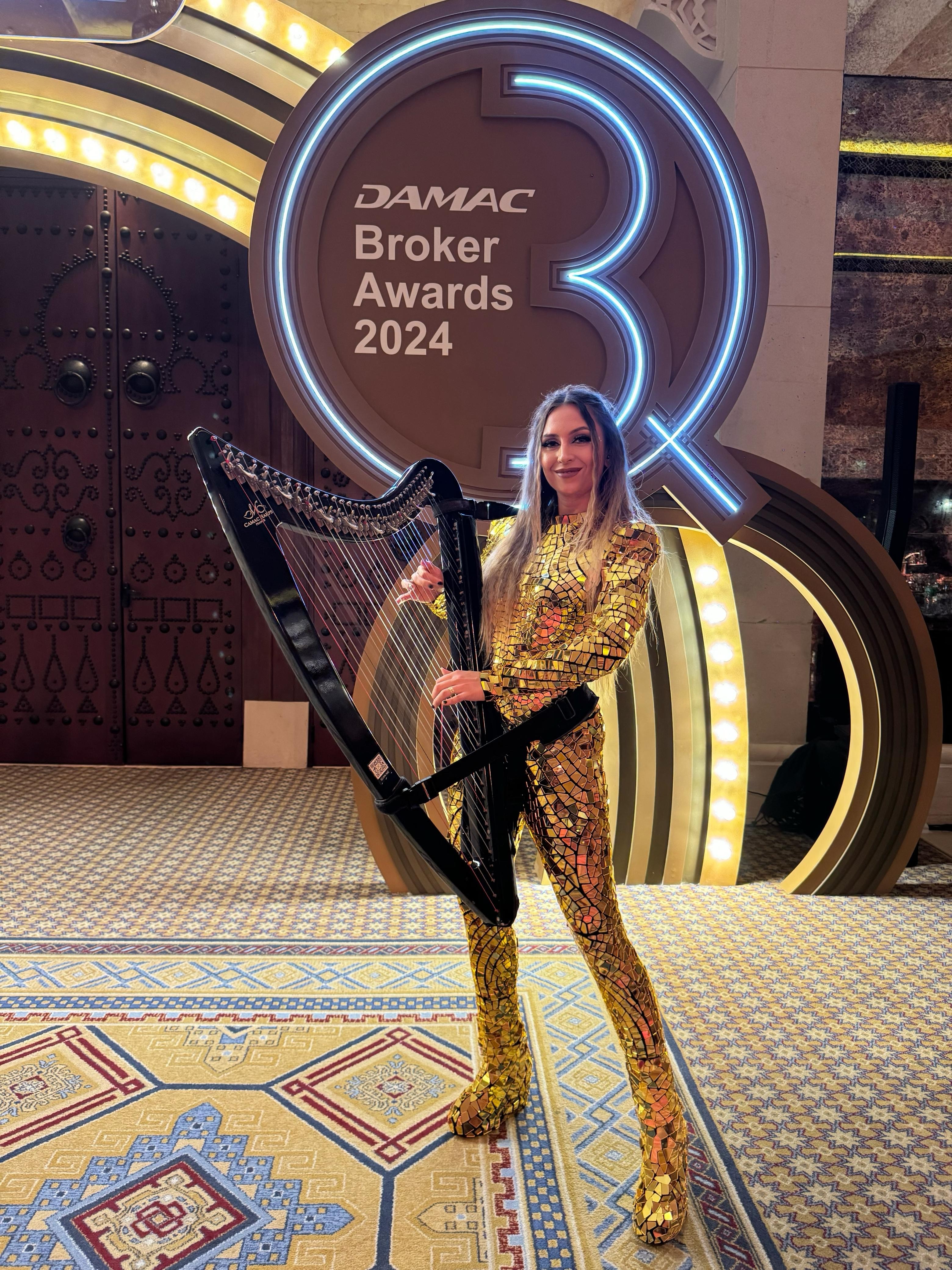 Gold mirror costume harpist performing live at DAMAC Broker Awards 2024 in Dubai