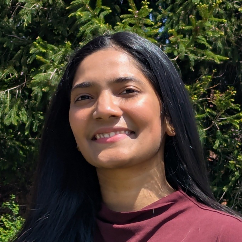 A person on a cozy studio smiling